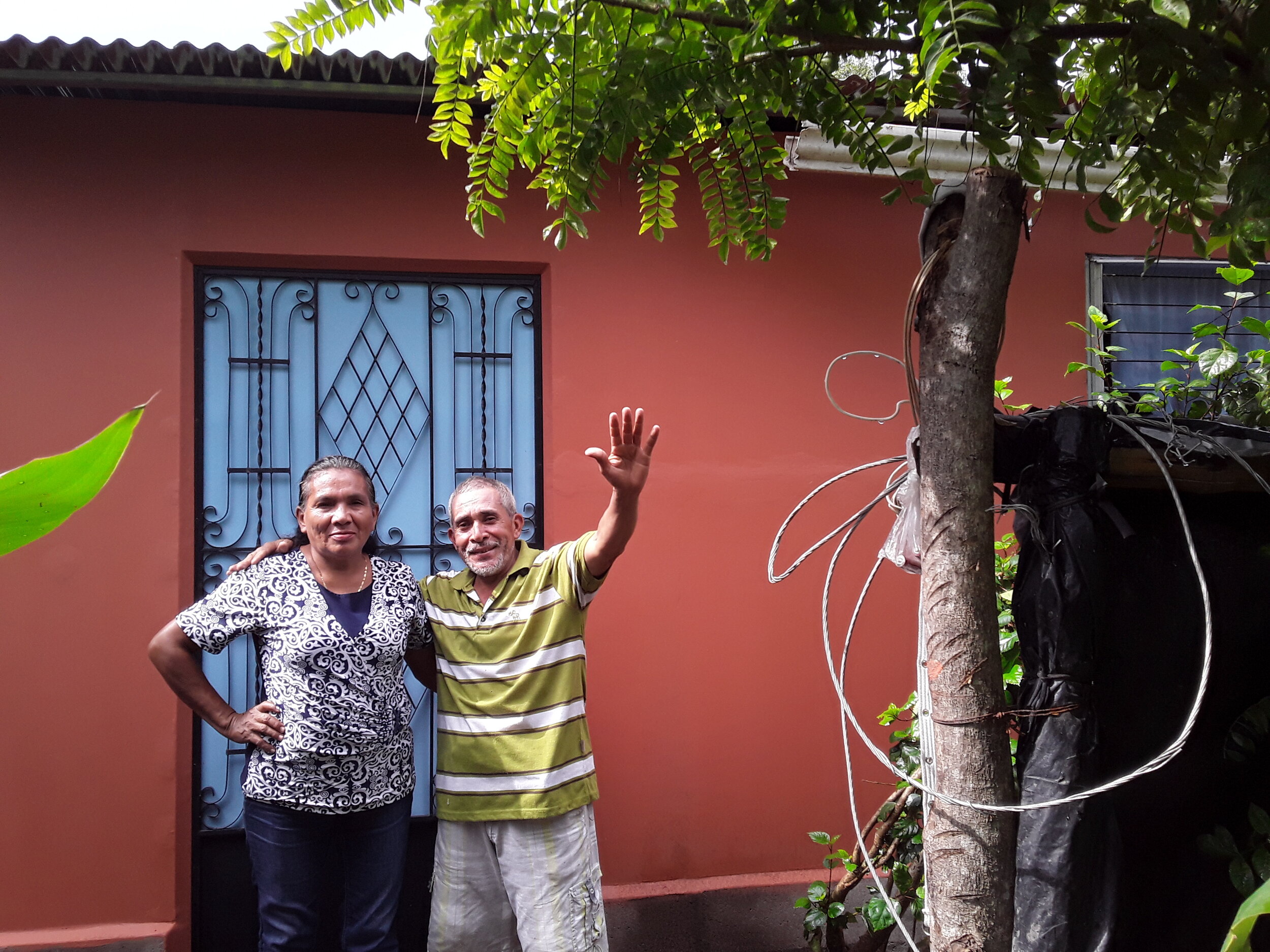 Greetings from El Salvador! This is Jose & Rosa Guzman, standing in front of their new home!
