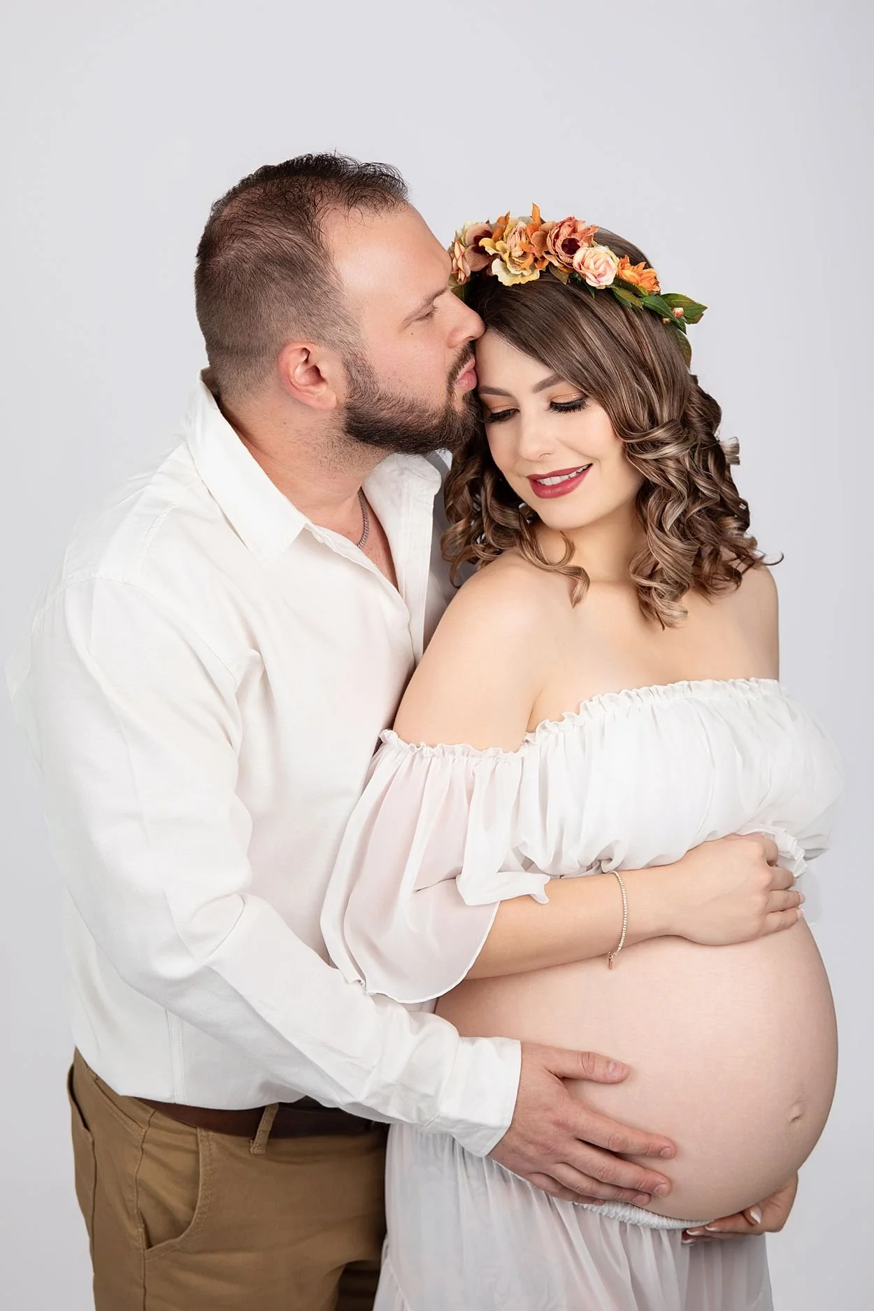 Studio Maternity Photographer in Chesterfield Virginia Just Outside of Williamsburg VA, Couple close together holding her belly in white tones