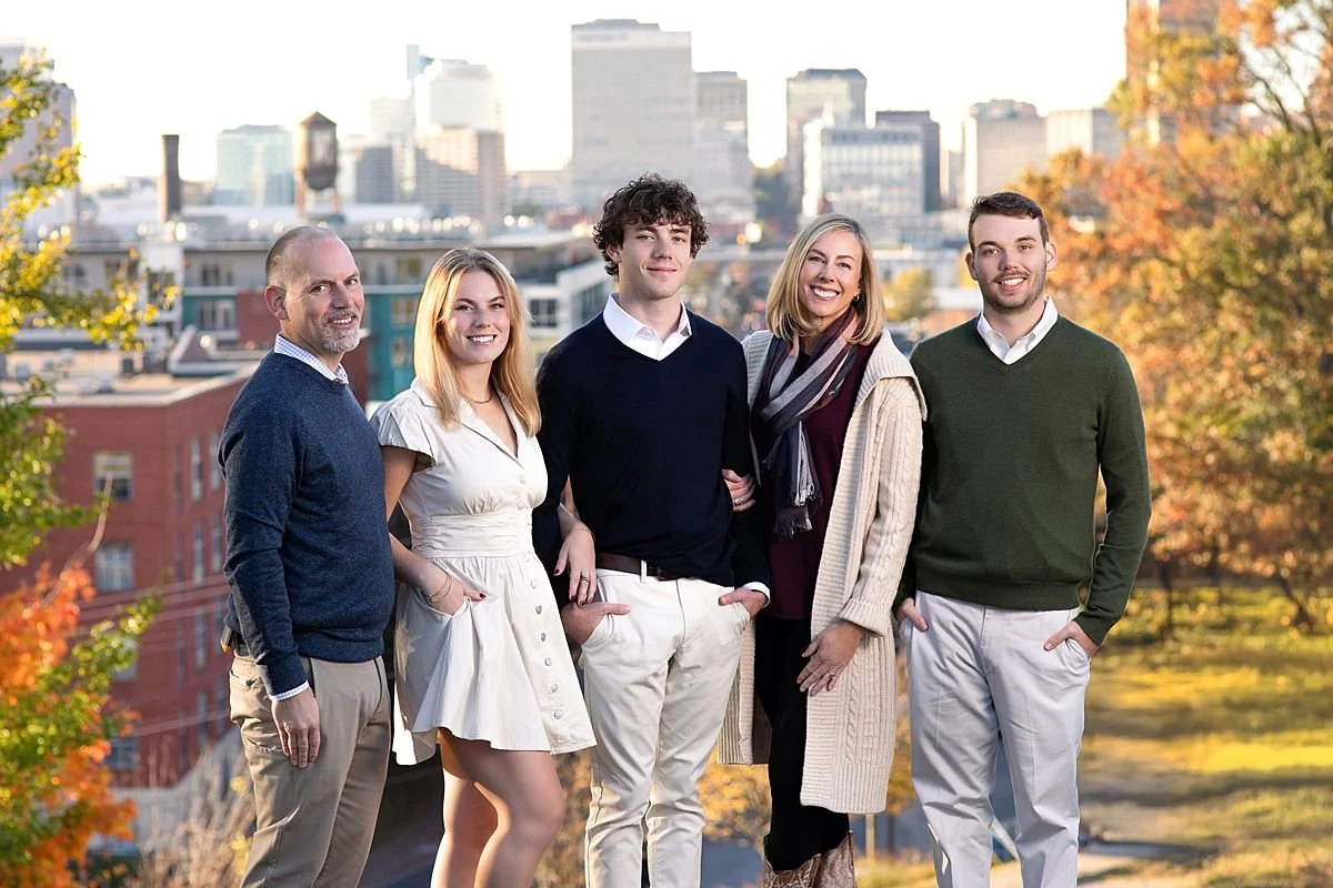 Fall family portraits at Libby Hill Park Richmond VA by photographer Sarah Kane, featuring families in autumn settings with city skyline views.