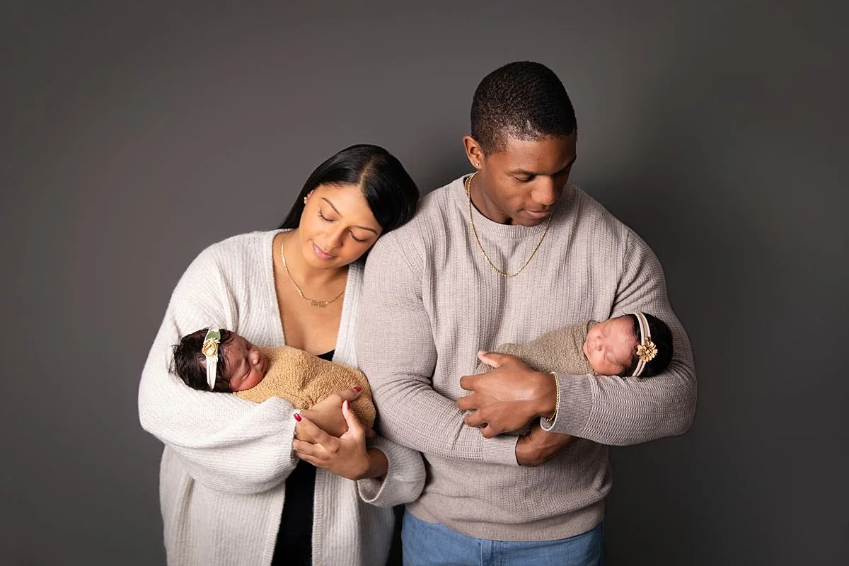 New parents gazing at newborn twins, Sarah Kane Photography, Richmond VA