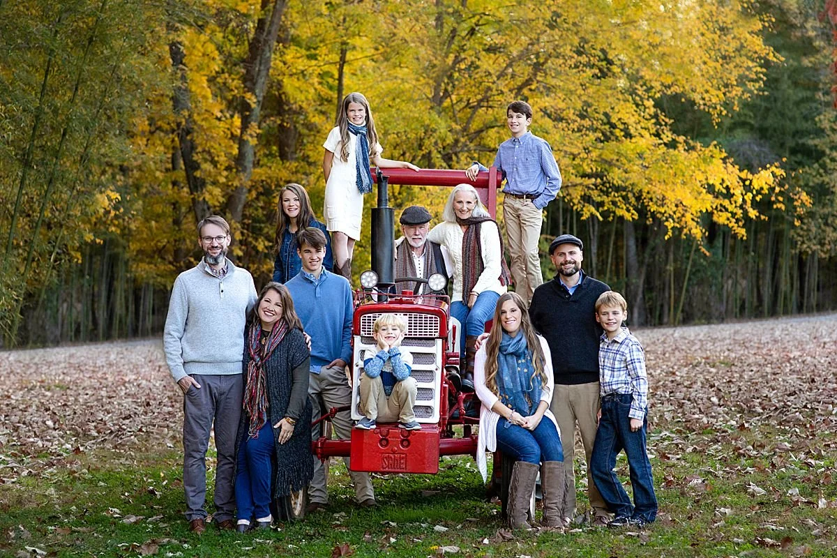 "Outdoor family portraits near Richmond Virginia | Large family photo with vintage tractor and autumn foliage