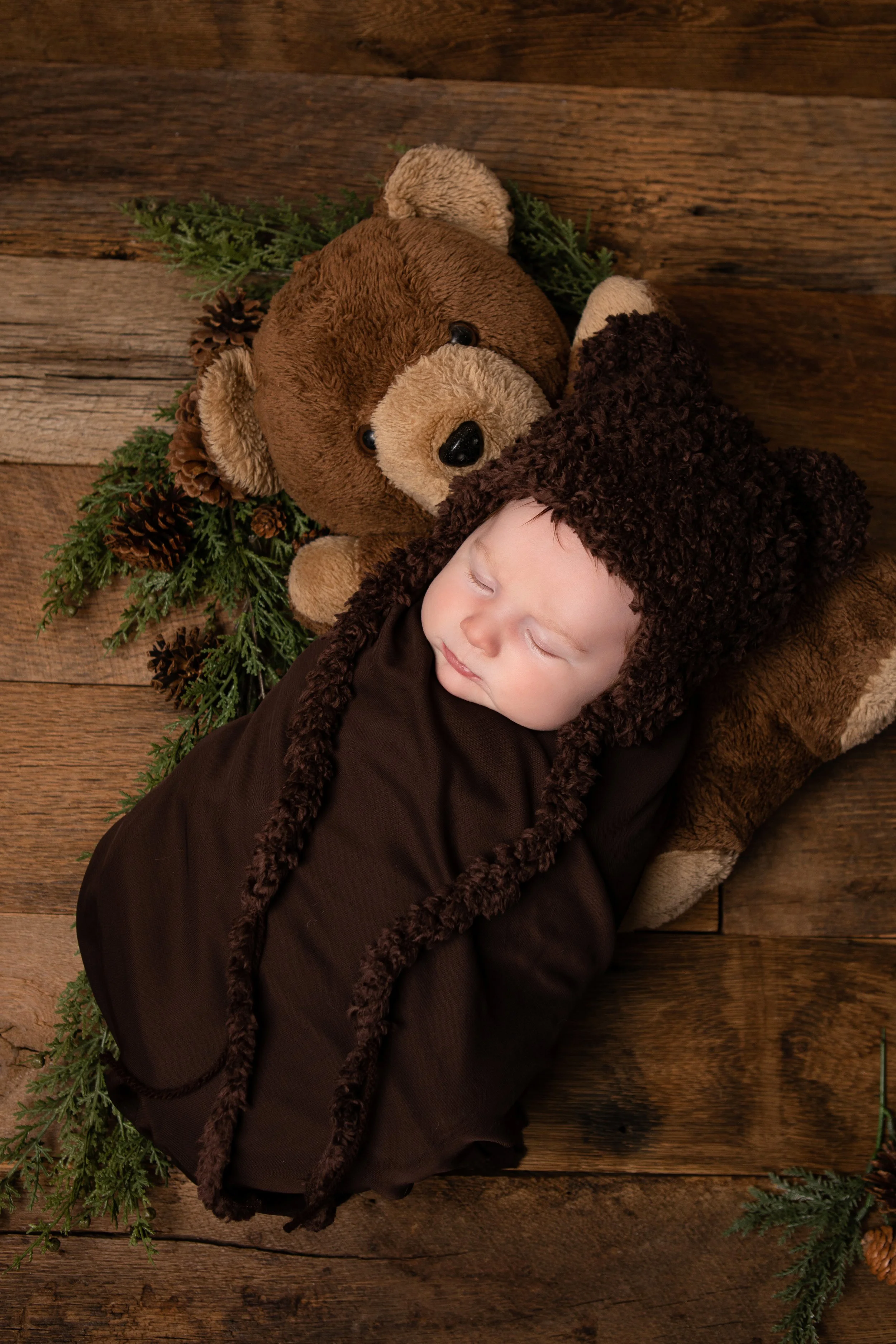 Newborn Session in My Chesterfield Virginia Studio, a sleeping newborn lays on a teddy bear wrapped in a cozy bear outfit
