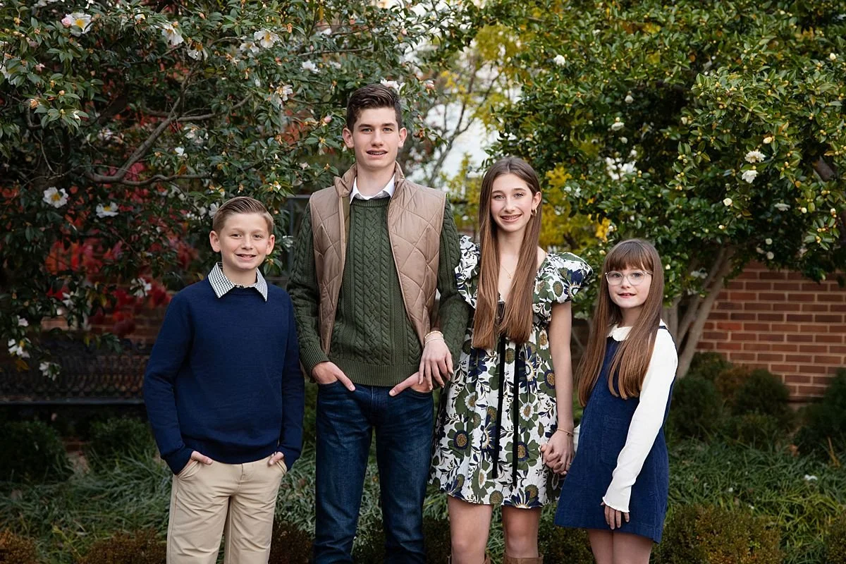 Portrait of four siblings at a park in Church Hill for family portraits in Richmond Virginia