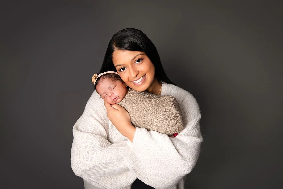 Glowing mom holding newborn twin,  Sarah Kane Photography