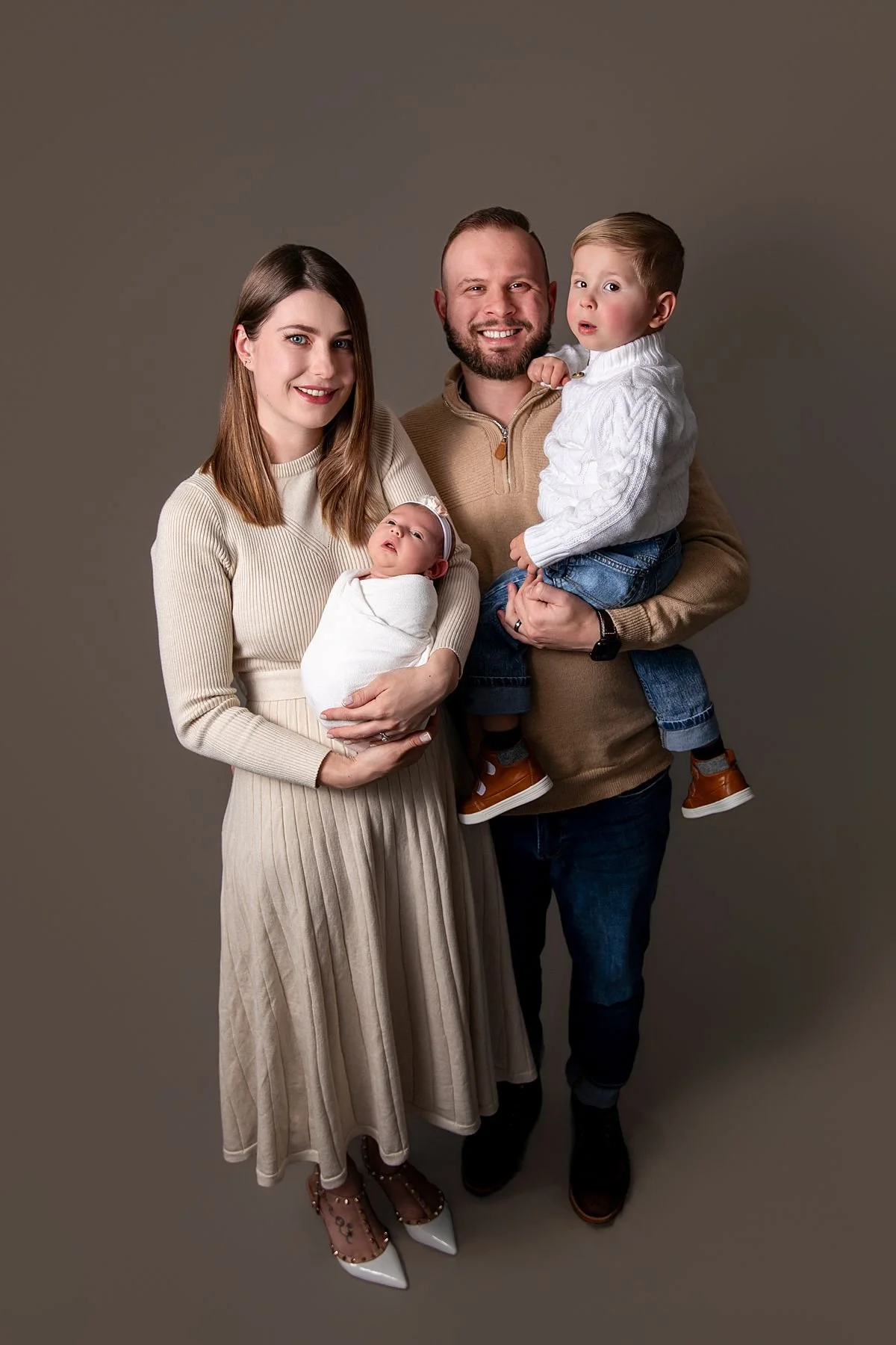Dad holding toddler son while mom cradles newborn baby girl, Sarah Kane Photography