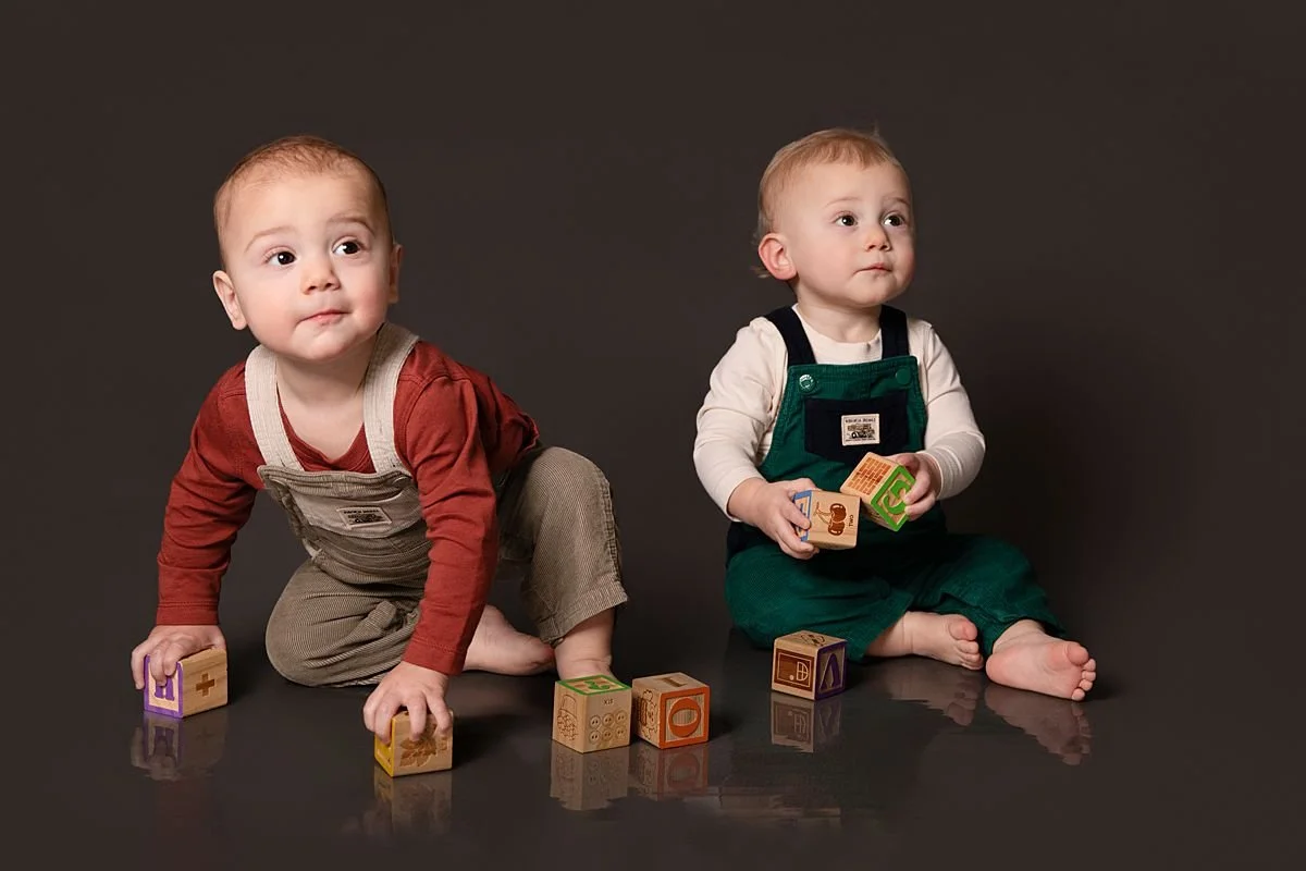 Twin one year olds sitting and playing with blocks by Sarah Kane Photography