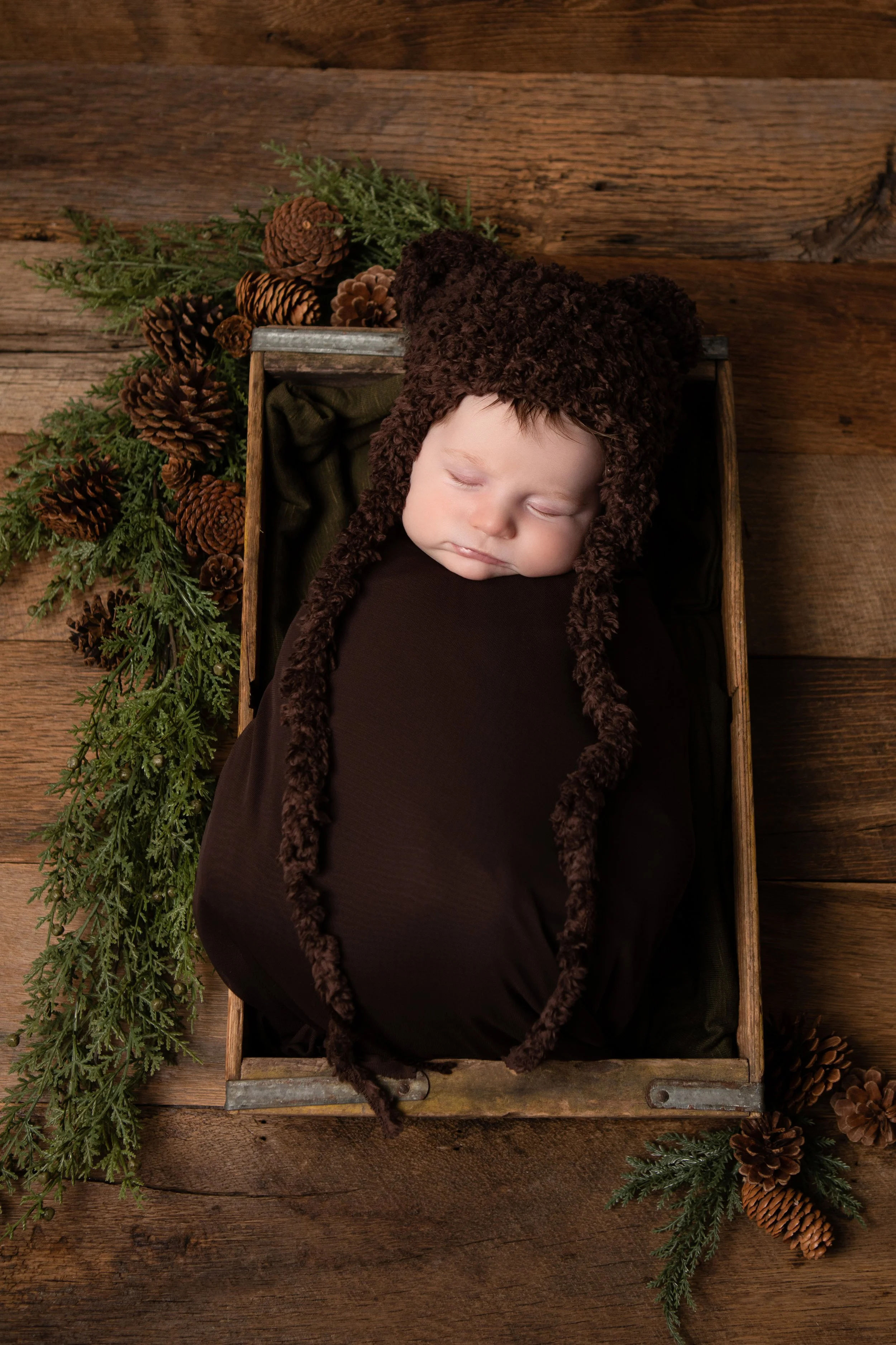 Newborn Session in My Chesterfield Virginia Studio, Newborn sleeping soundly in a rustic wooden box dressed in a soft bear outfit