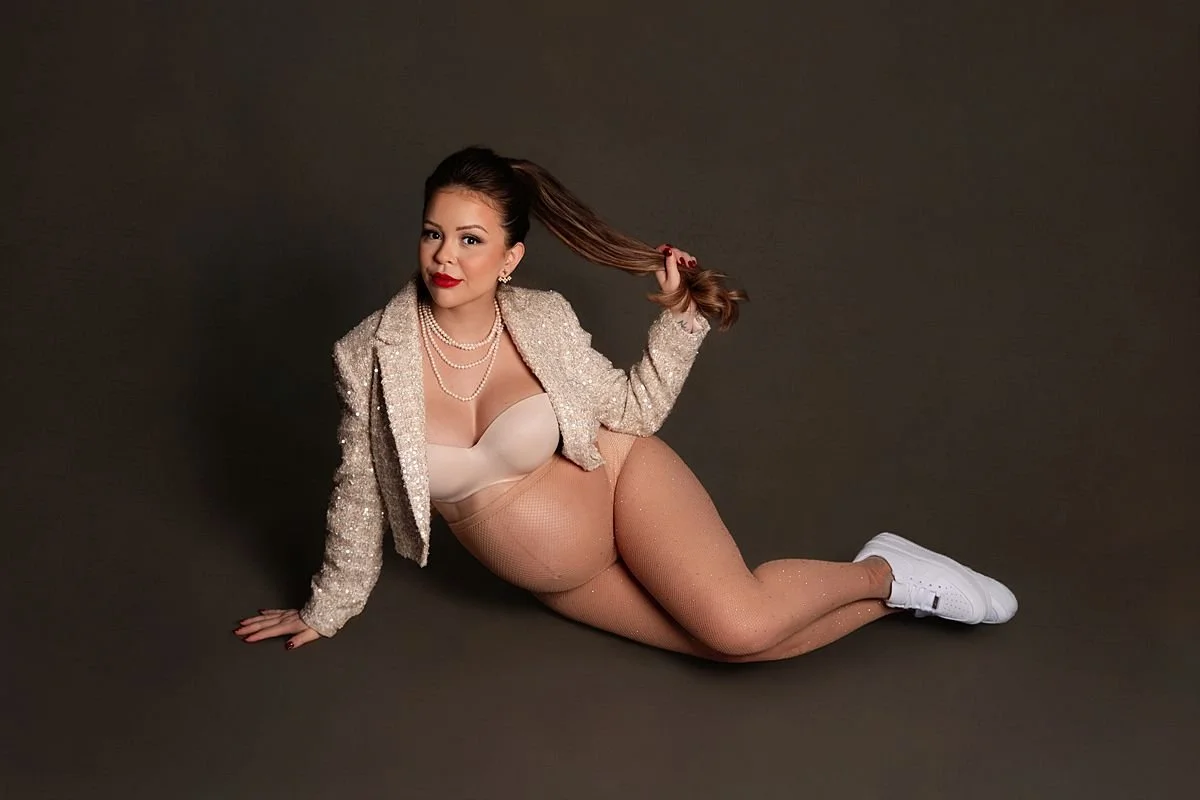 Glamorous pregnant woman on studio floor tossing her ponytail, Sarah Kane Photography, Chesterfield VA