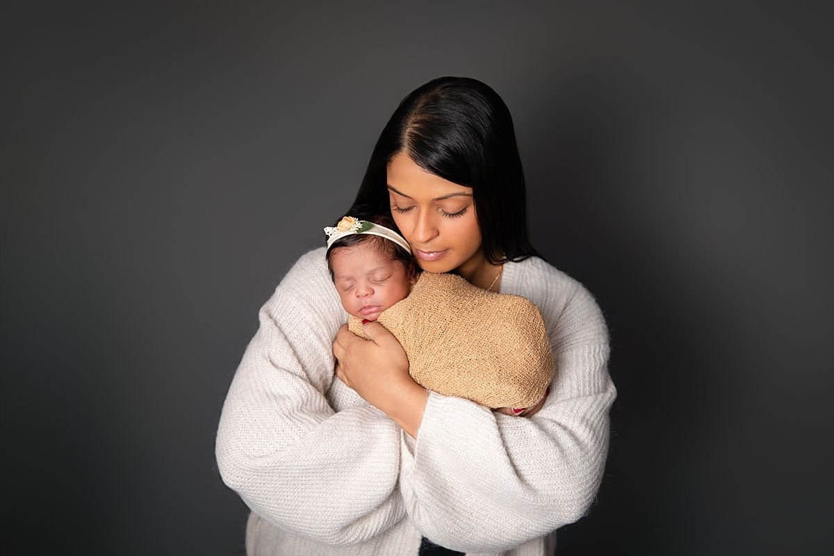 Mother cradling swaddled newborn twin, Sarah Kane Photography, Chesterfield VA