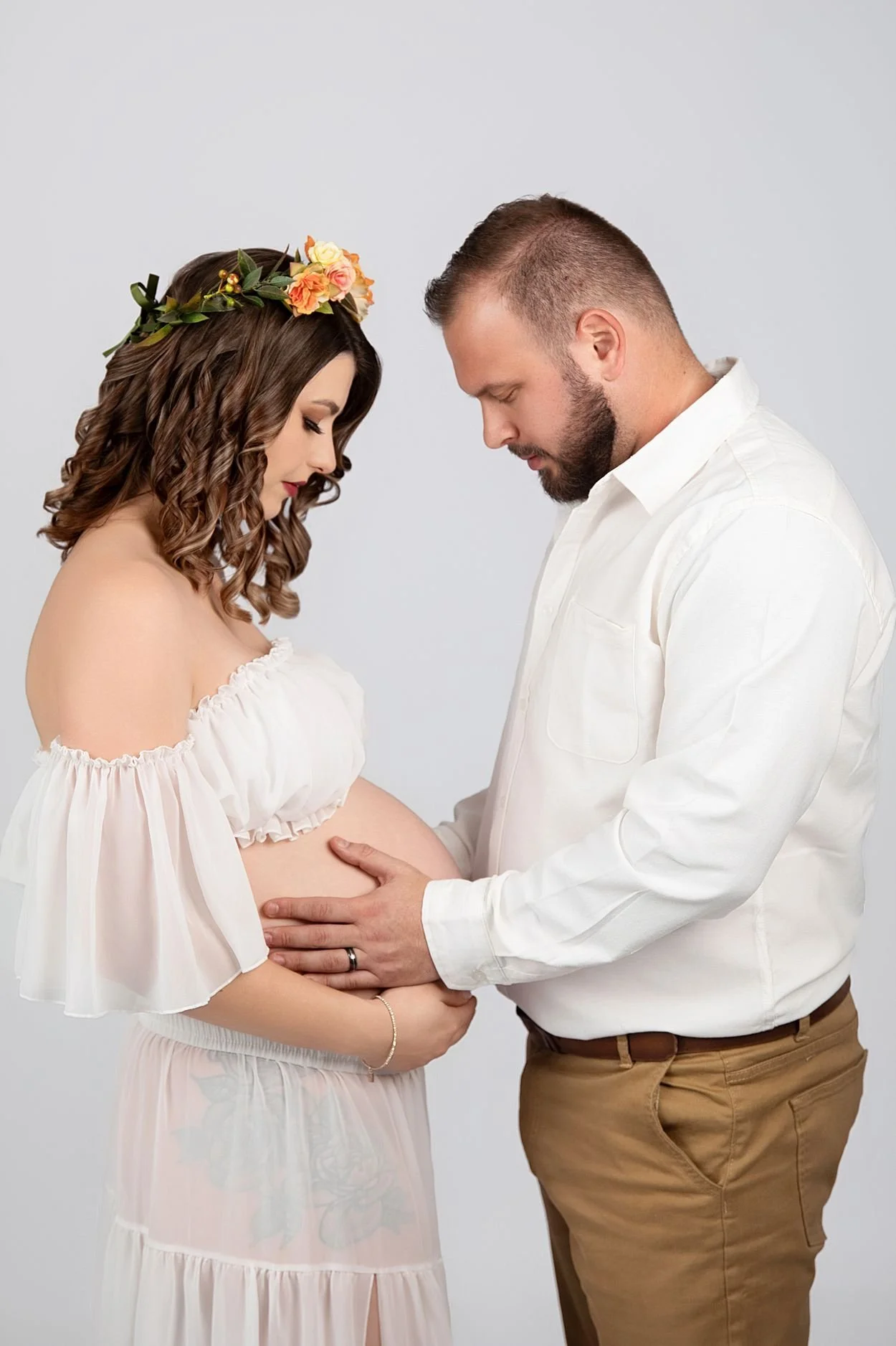 Studio Maternity Photographer in Chesterfield Virginia Just Outside of Williamsburg VA, Couple facing each other with heads down and gently touching her belly
