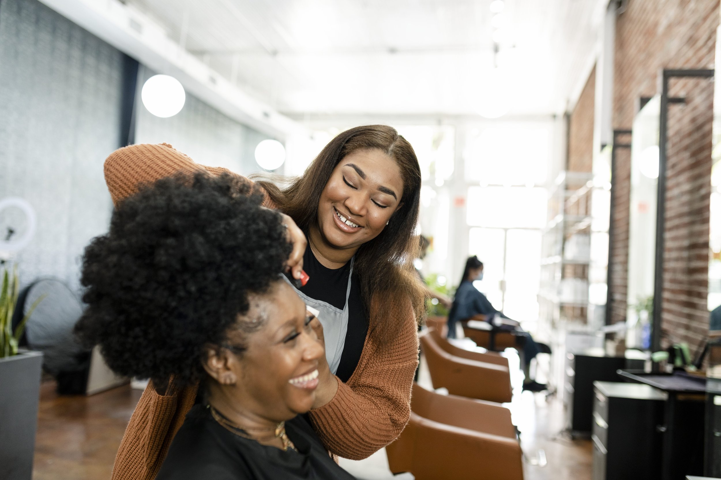 hairstylist-trimming-the-customer-39-s-hair-at-a-2023-11-27-05-19-10-utc.jpg