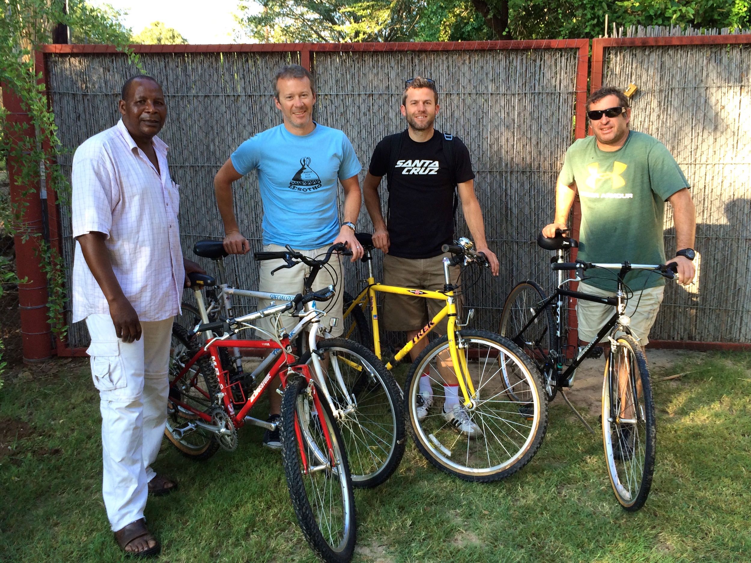 Trinos with Ken, Matt and Paul, and a few of the bikes he has available for sale in Shakawe. They've made a long long journey from California.