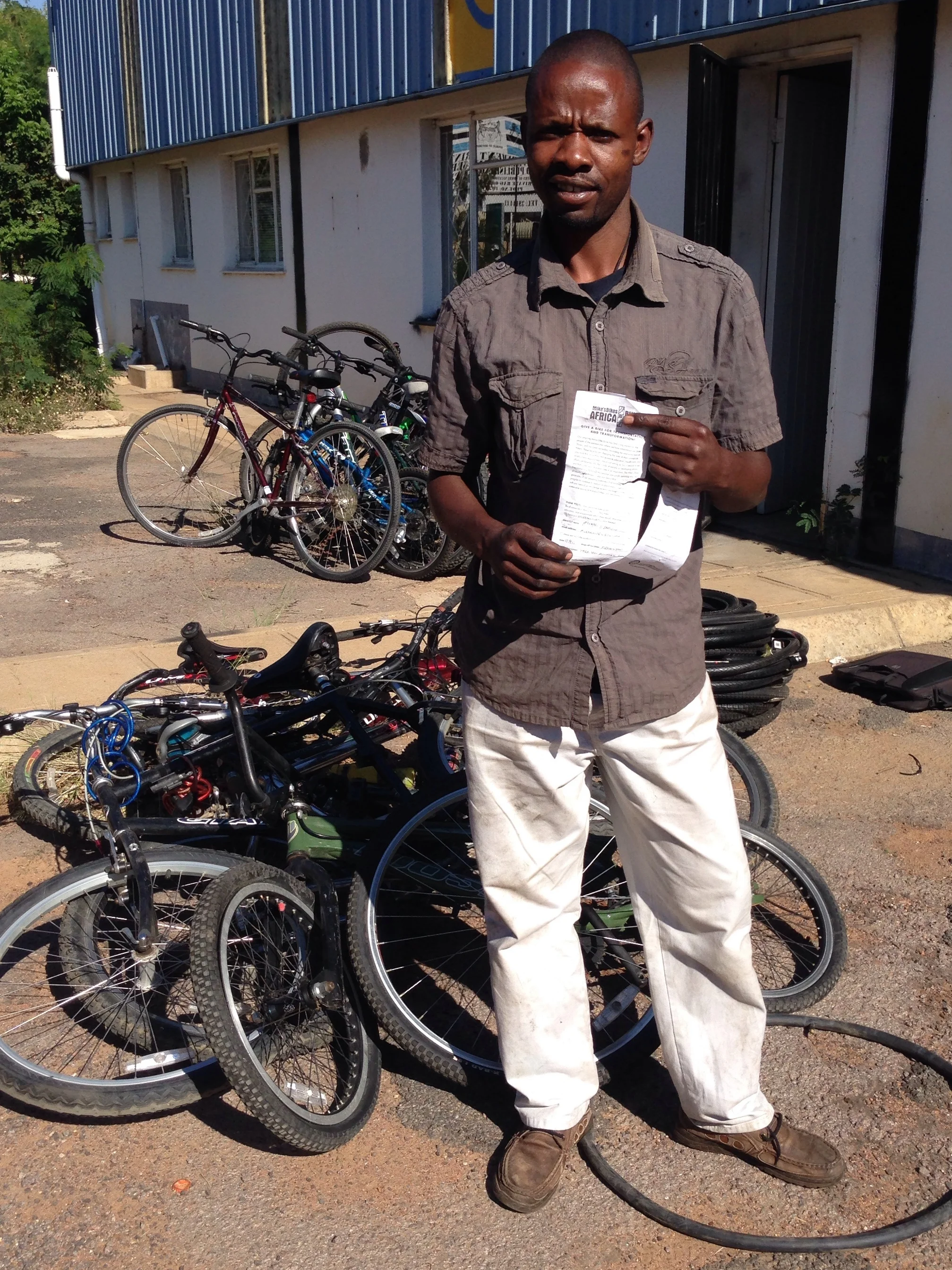 Enoch with his new stock and slips from our bike donors in California.