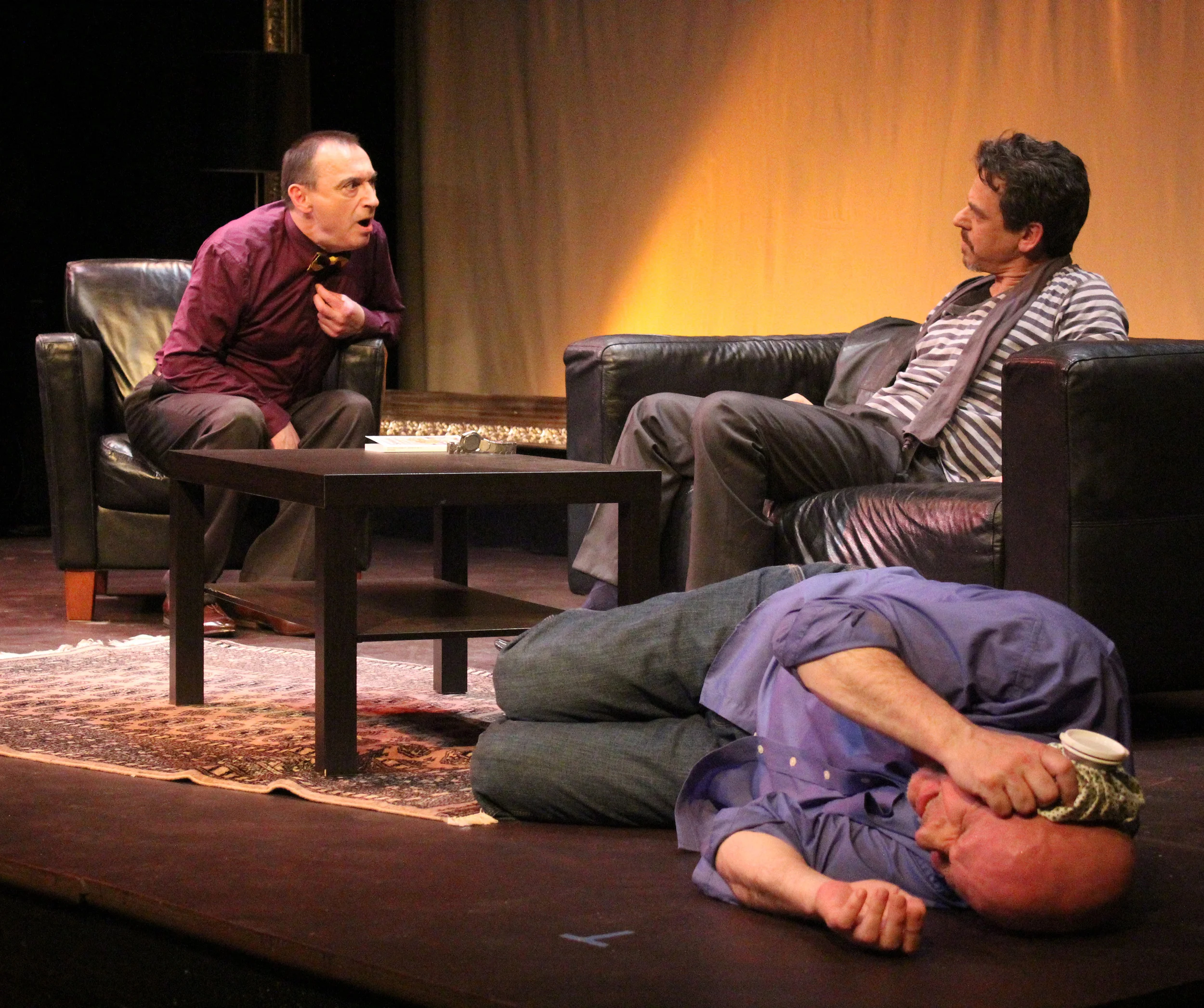 Yvan (Andy Massingham) does his best to remain calm as Serge (Robert Marinier, left) and Marc (David Frisch) tangle in 'Art' Photography by Julie Le Gal