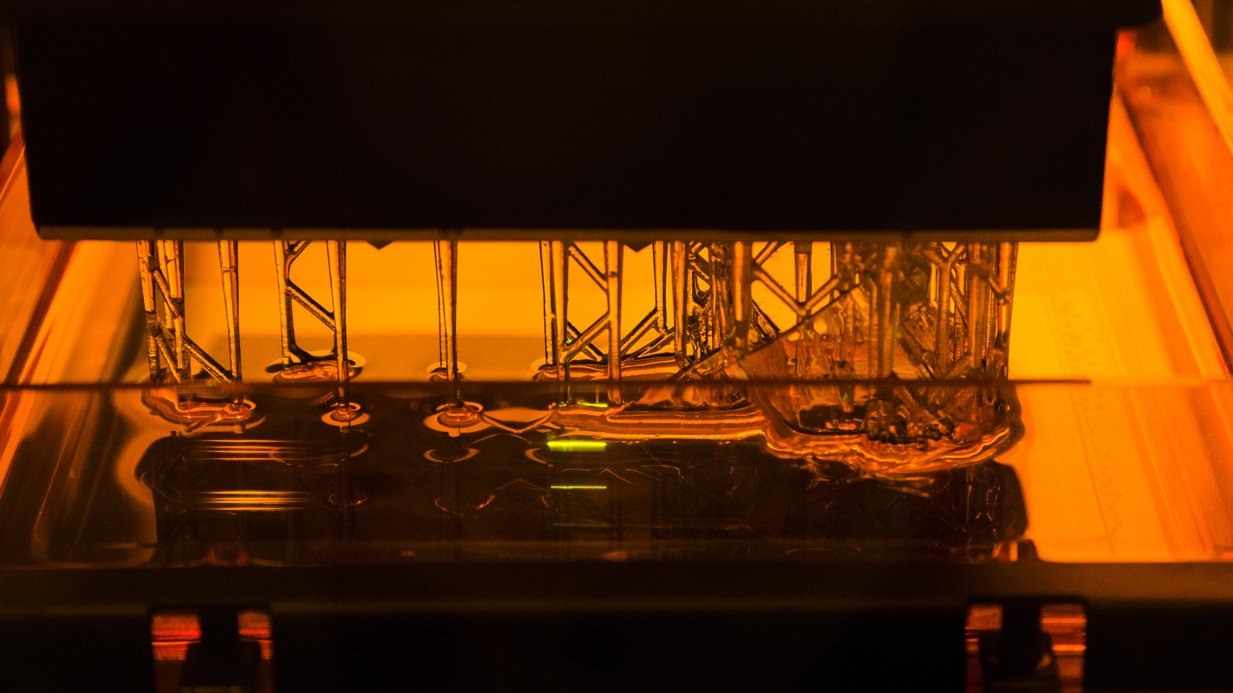 An SLA 3D Printer turning resin from liquid to solid. (Source: http://bit.ly/2ytU47W)