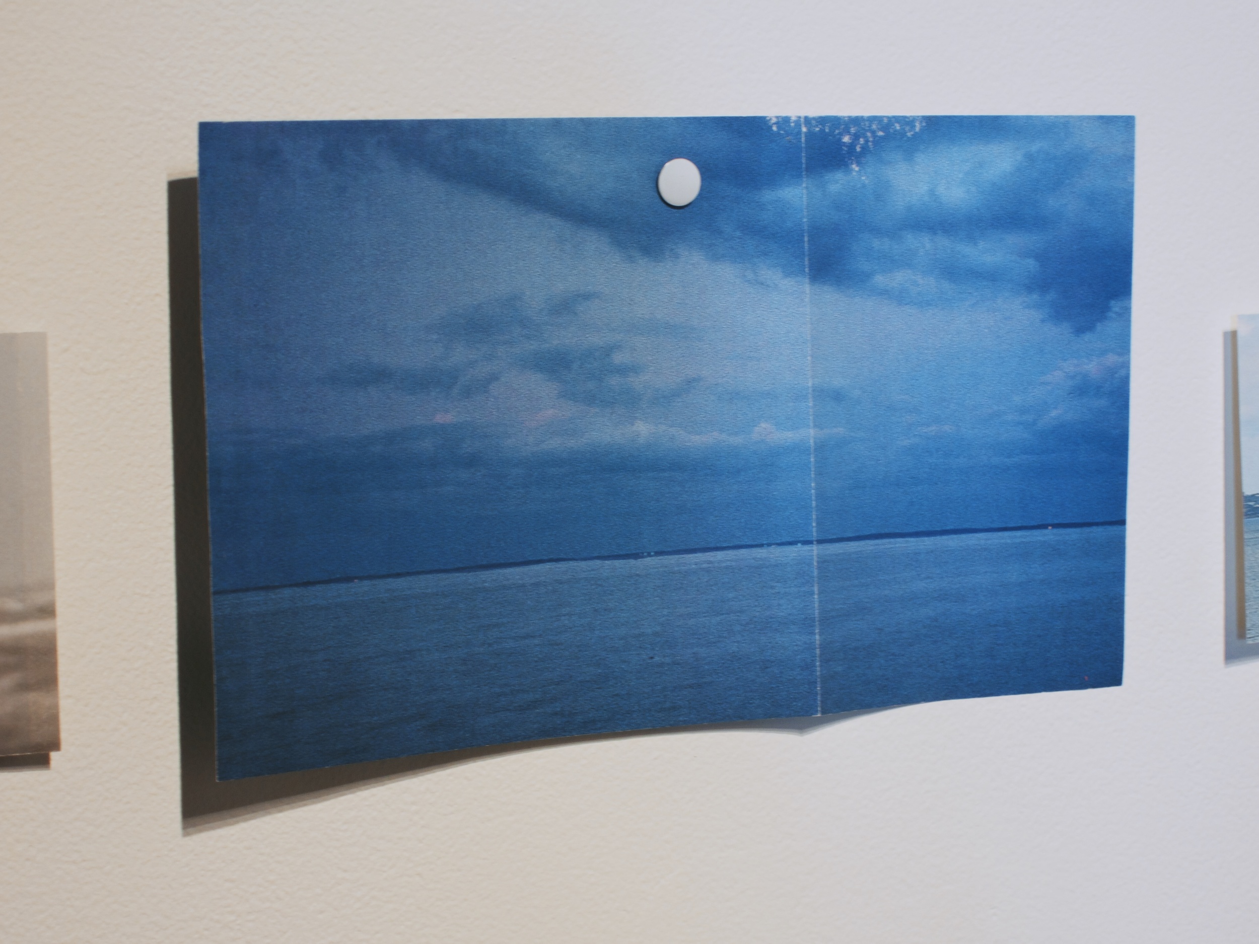  Cut out National Geographic image of ocean horizon pinned to the wall,&nbsp;2014. 