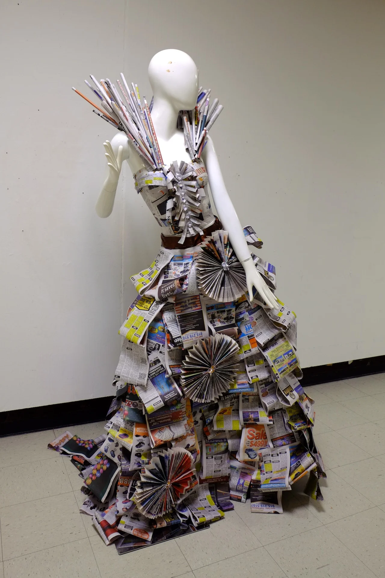 Made at University of Texas at El Paso in Introductory Sculpture, newspaper advertisements draped over dress model, 6x3x4 feet, 2015. 