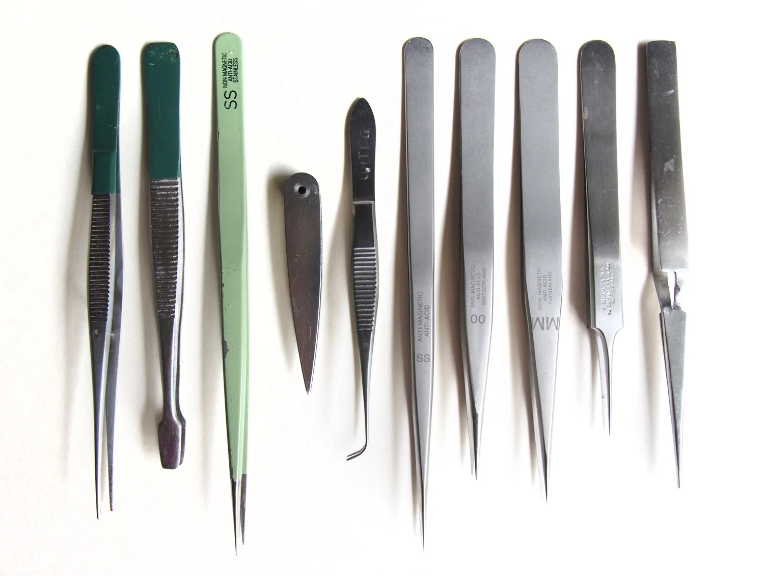 Tweezers, largely "borrowed" from my dad, who used to be a doctor. The pale green one is the best; pointy but not too pointy, flexible but not too flexible, sleek. Regine, epoxy-coated stainless steel.