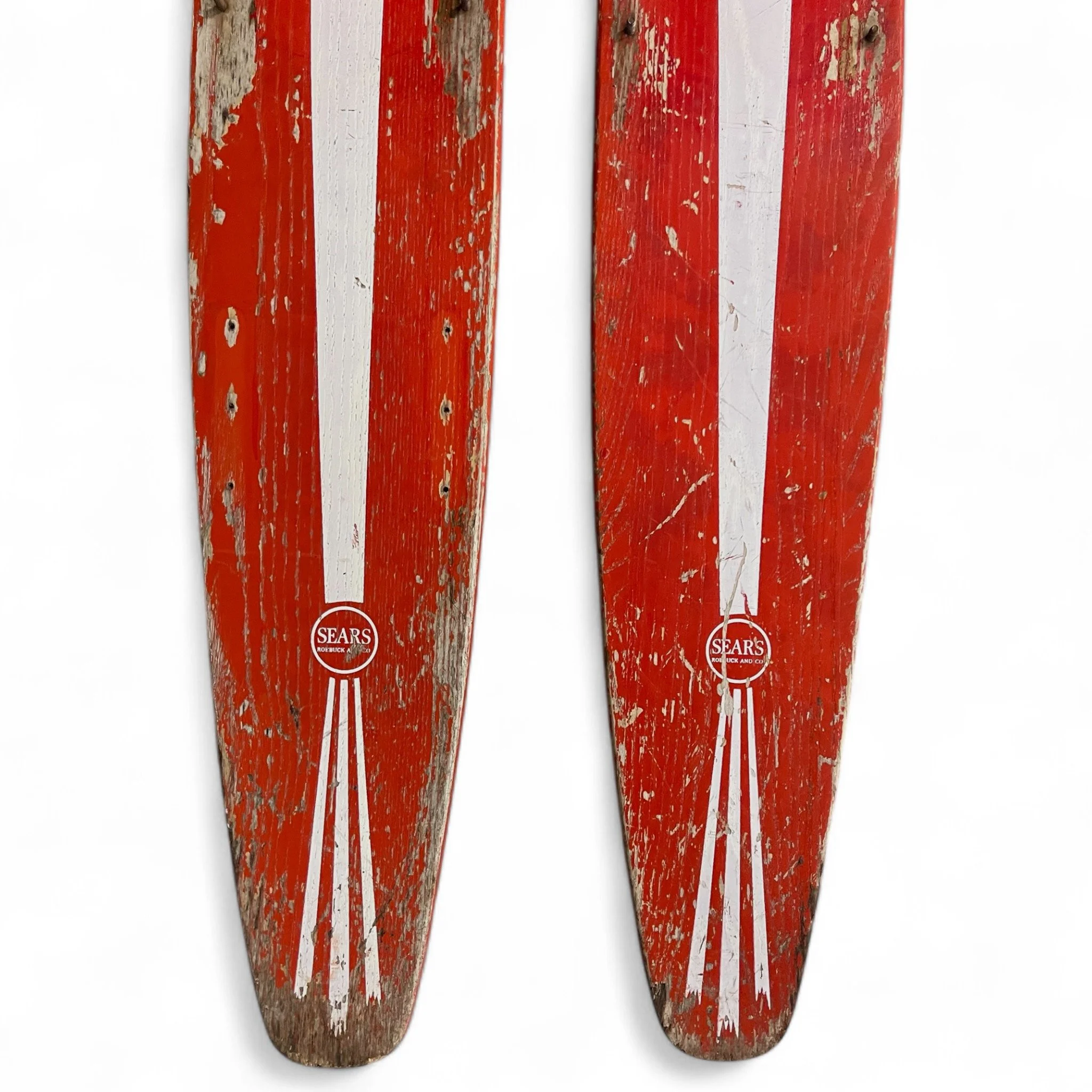 Vintage pair of red white Sears Shorty Combo wooden water skis, well weathered and perfect for beach house decor.