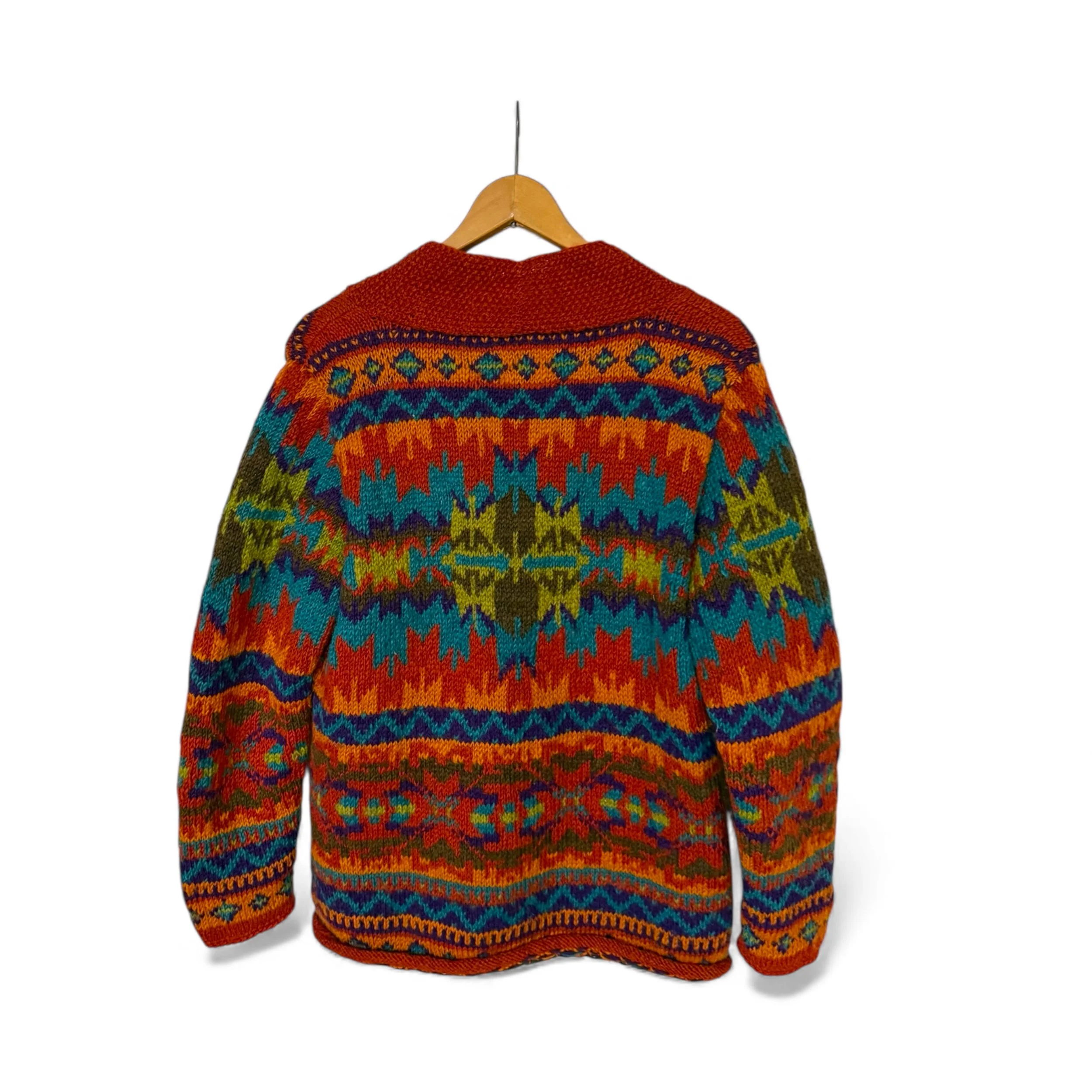 vintage Lost Horizons wool sweater hanging on a hanger, back view showing full geometric multicolor knit design.