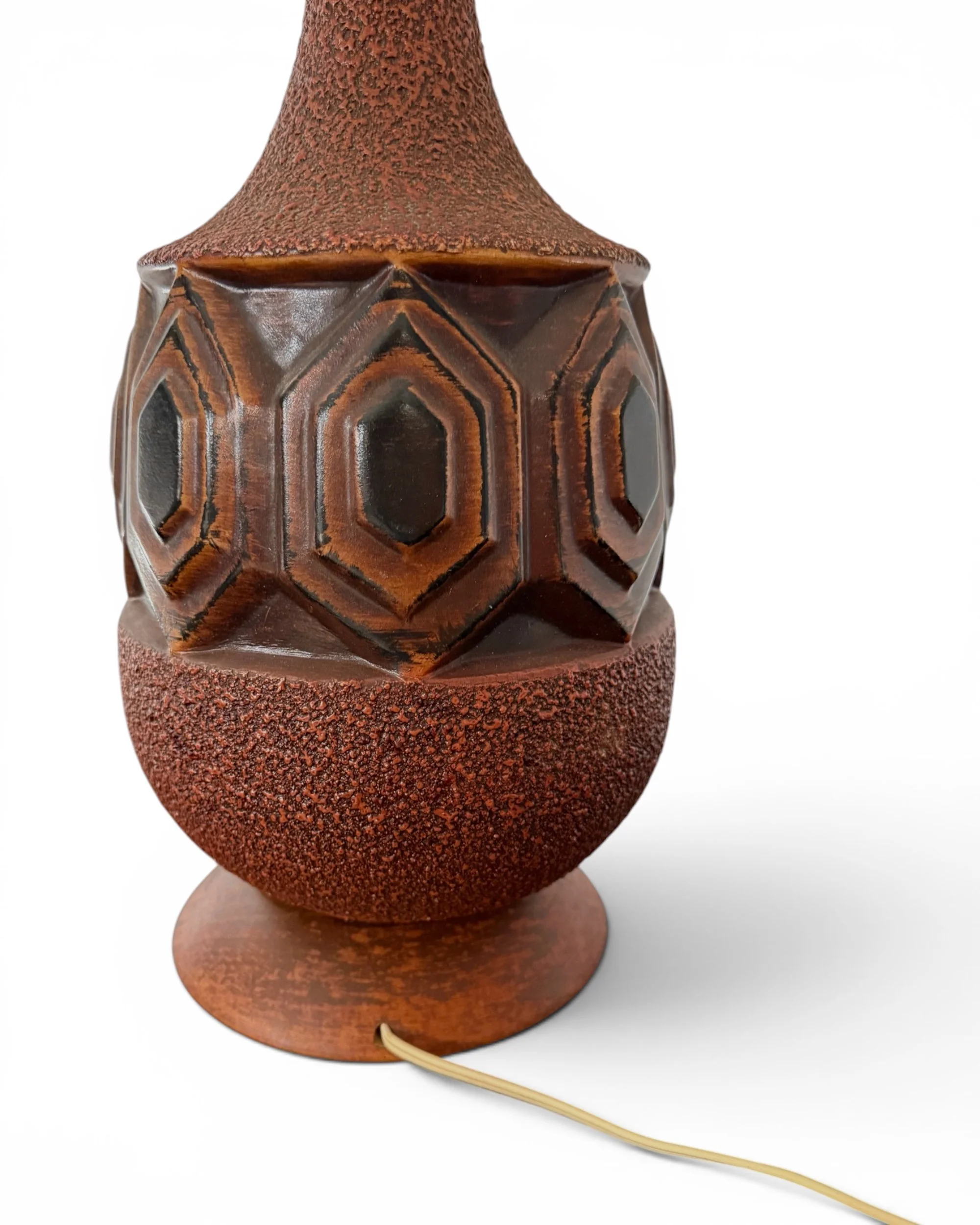 Close up of raised geometric ceramic pattern on vintage mid century lamp