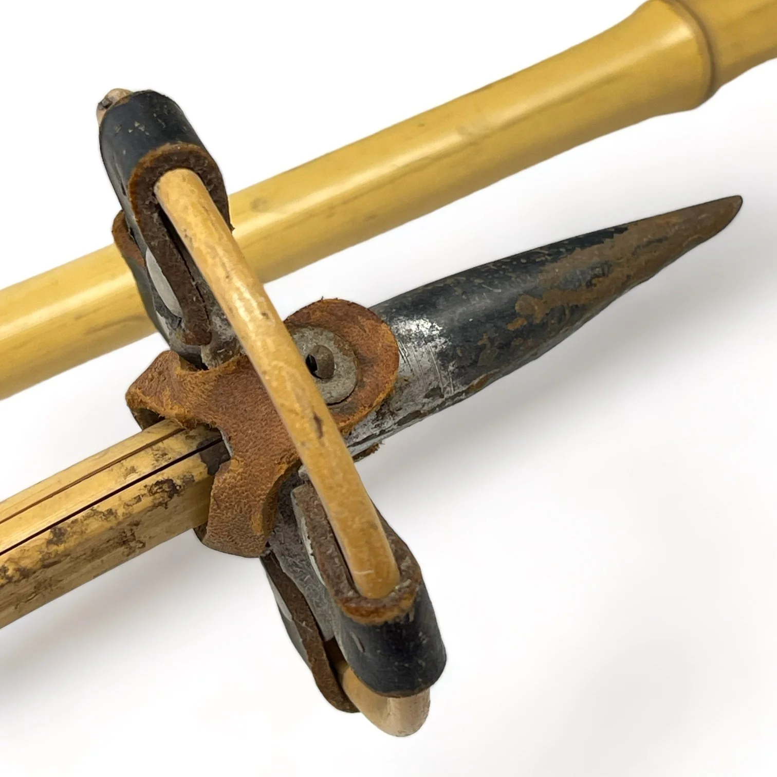 Vintage kids bamboo ski pole, featuring metal tip, bamboo shaft, and bamboo and leather shaft.