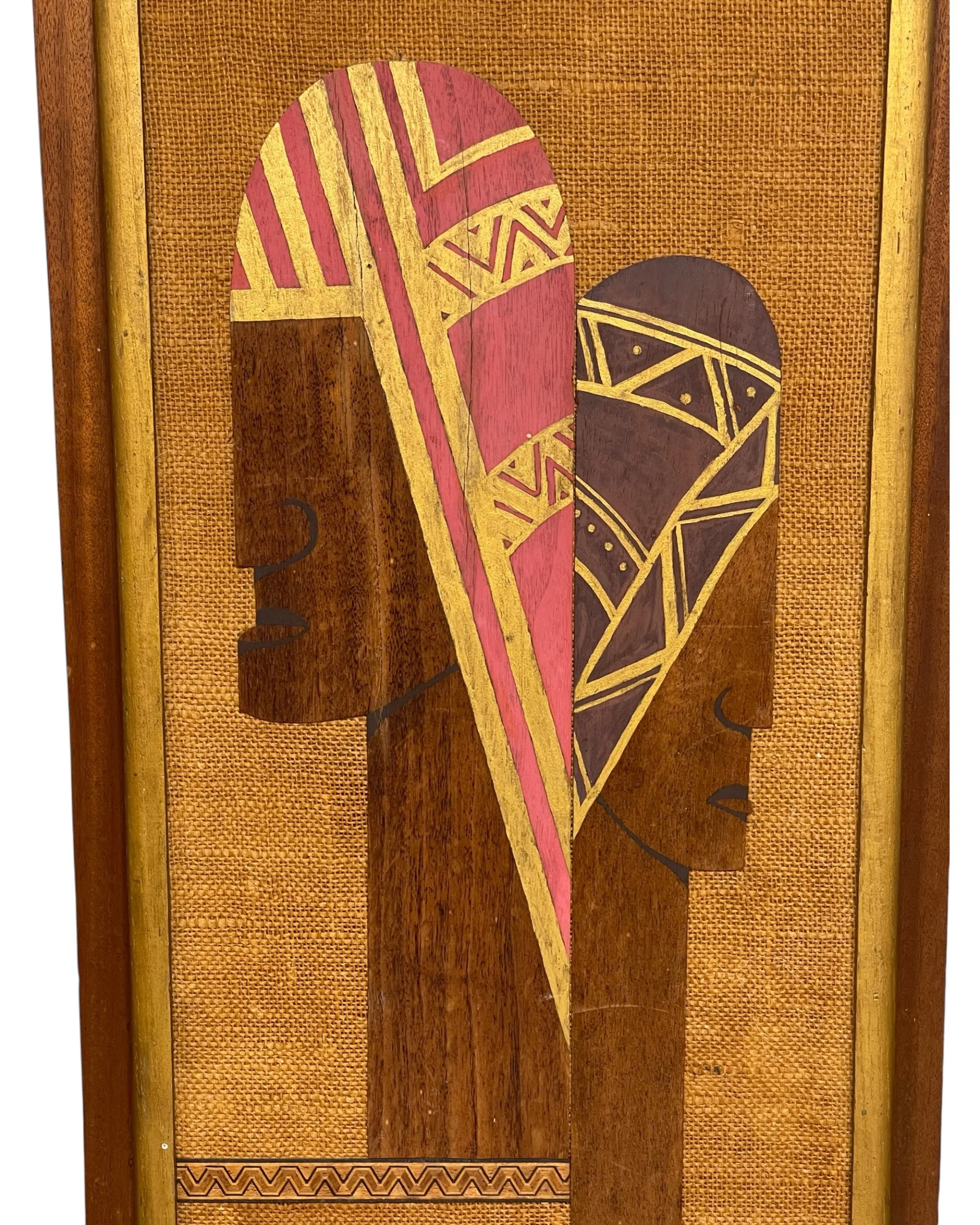 Close up marquetry inlay wood tribal face mid century wall art in pink, gold, brown colors