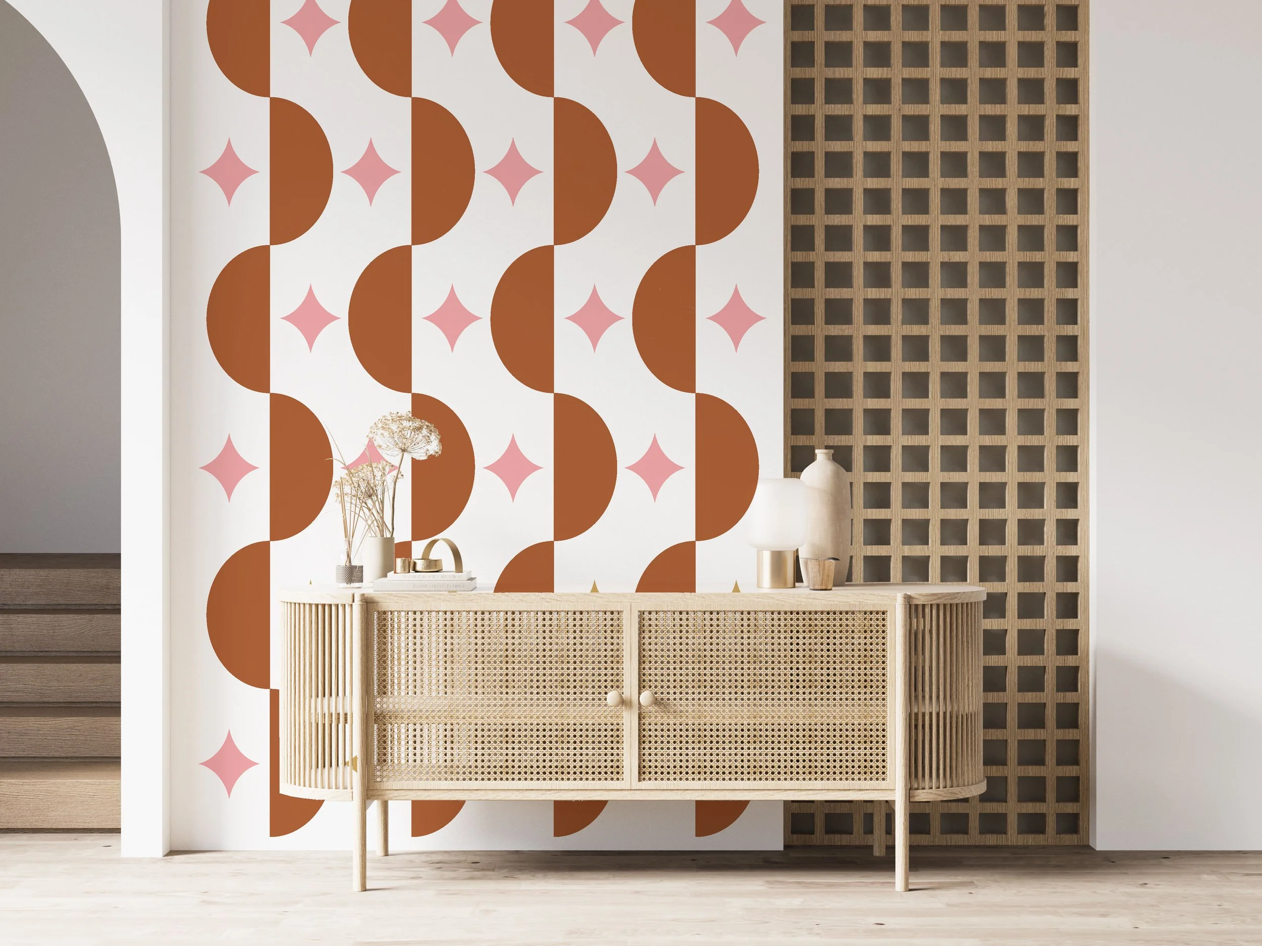 Modern wall decal pattern of half circles and atomic stars buy Wall Star Graphics shown in nut brown and carnation pink on a whitewall with a wood credenza in a boho styled interior.