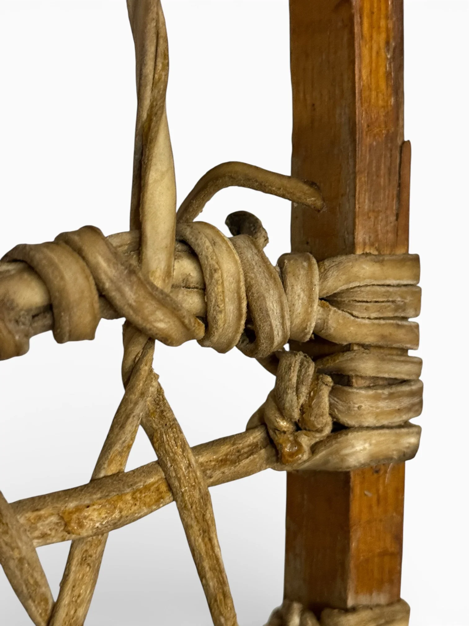 Detail of rawhide lacing and aged wood frame on antique snowshoes