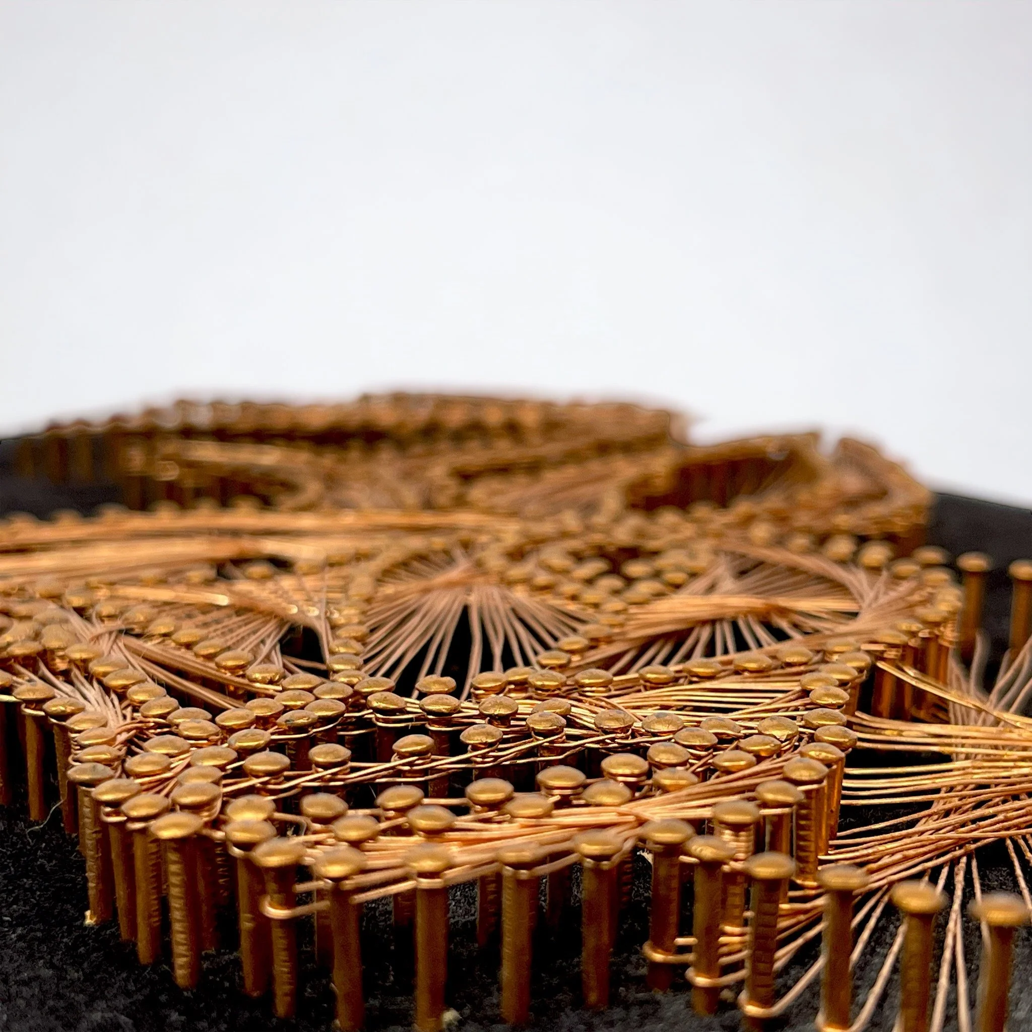 Vintage copper string art of a male deer, buck, on a black velvet board.