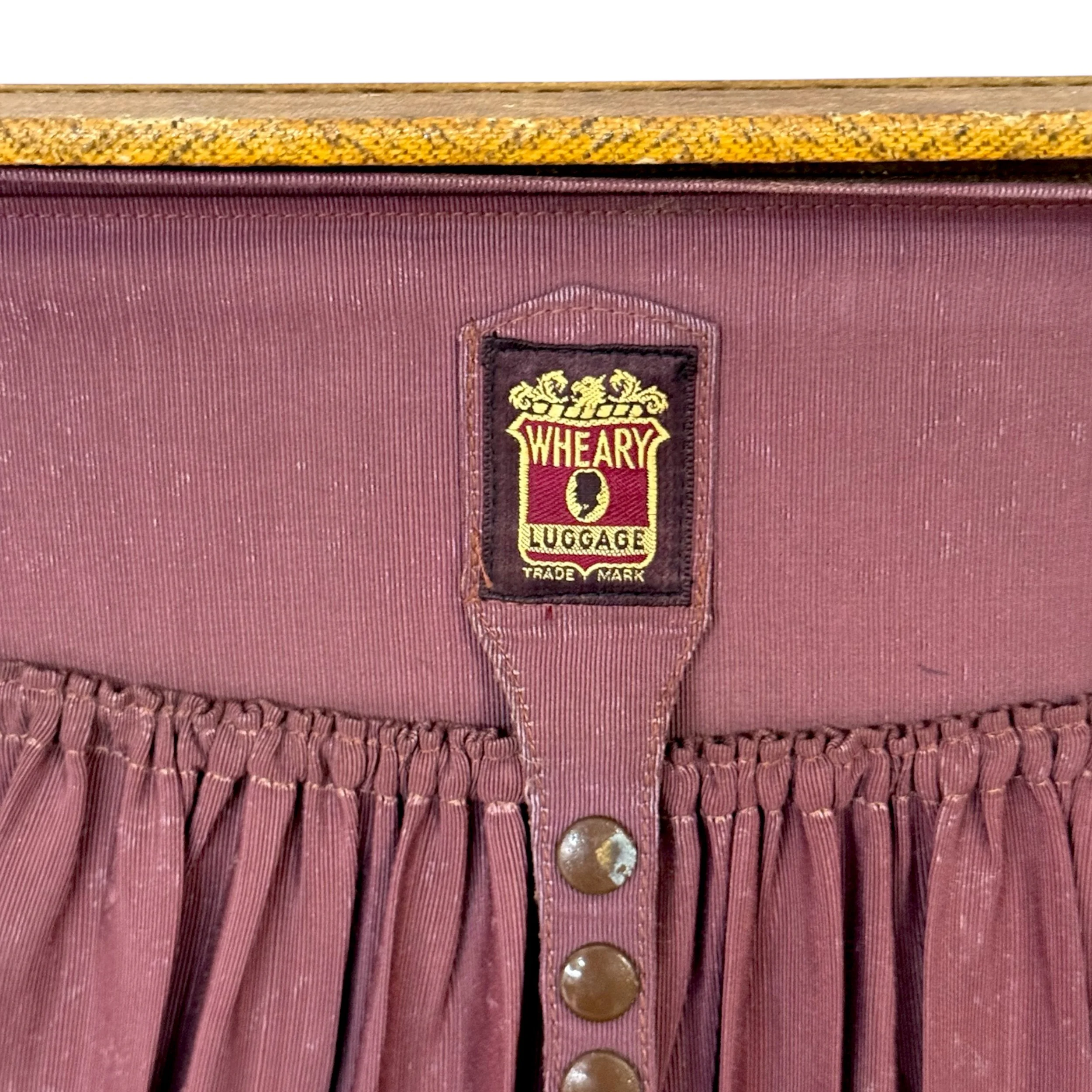 Close up view of Wheary Luggage label on the interior of an antique travel suitcase