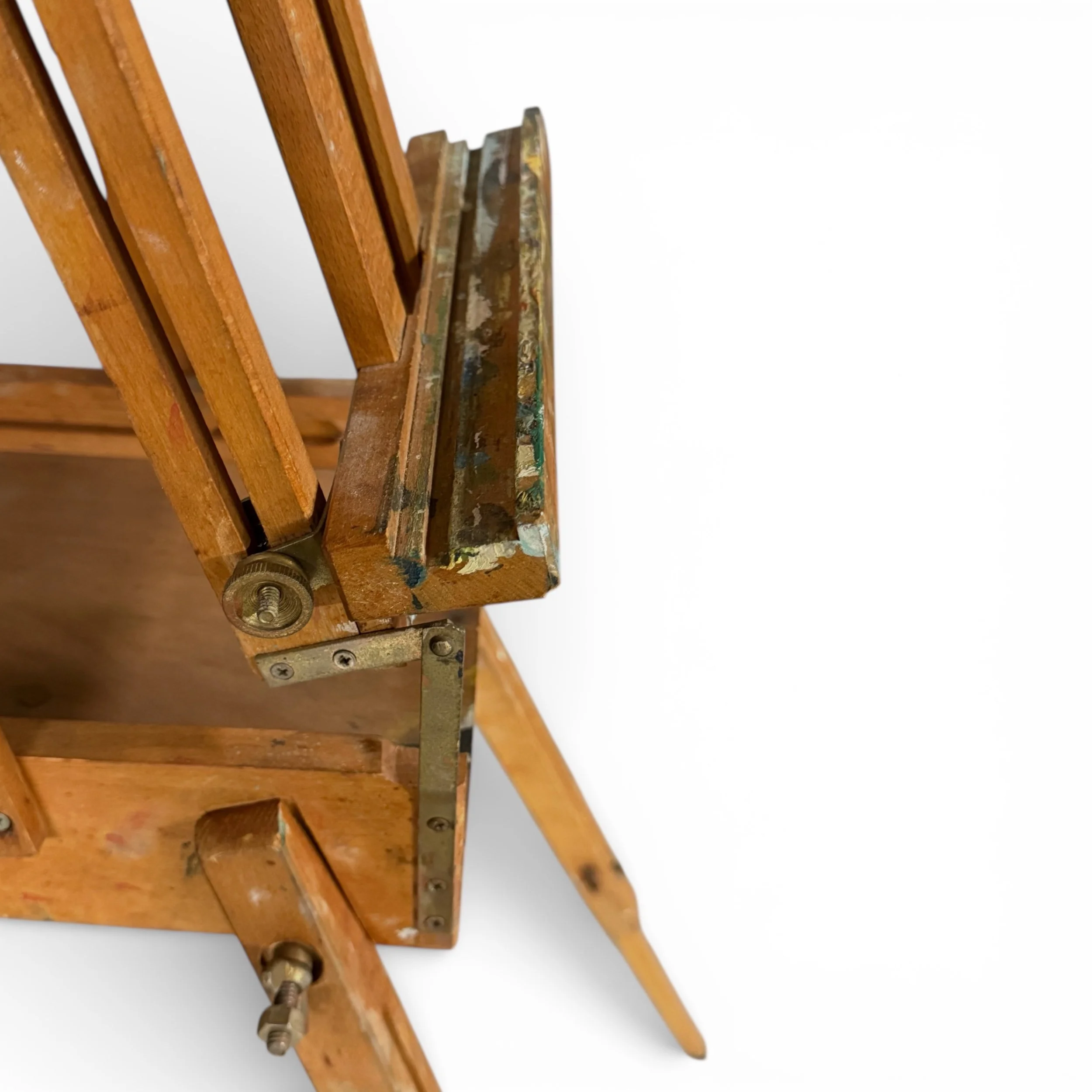 close up side view of tray with dried paint on a vintage wooden French easel