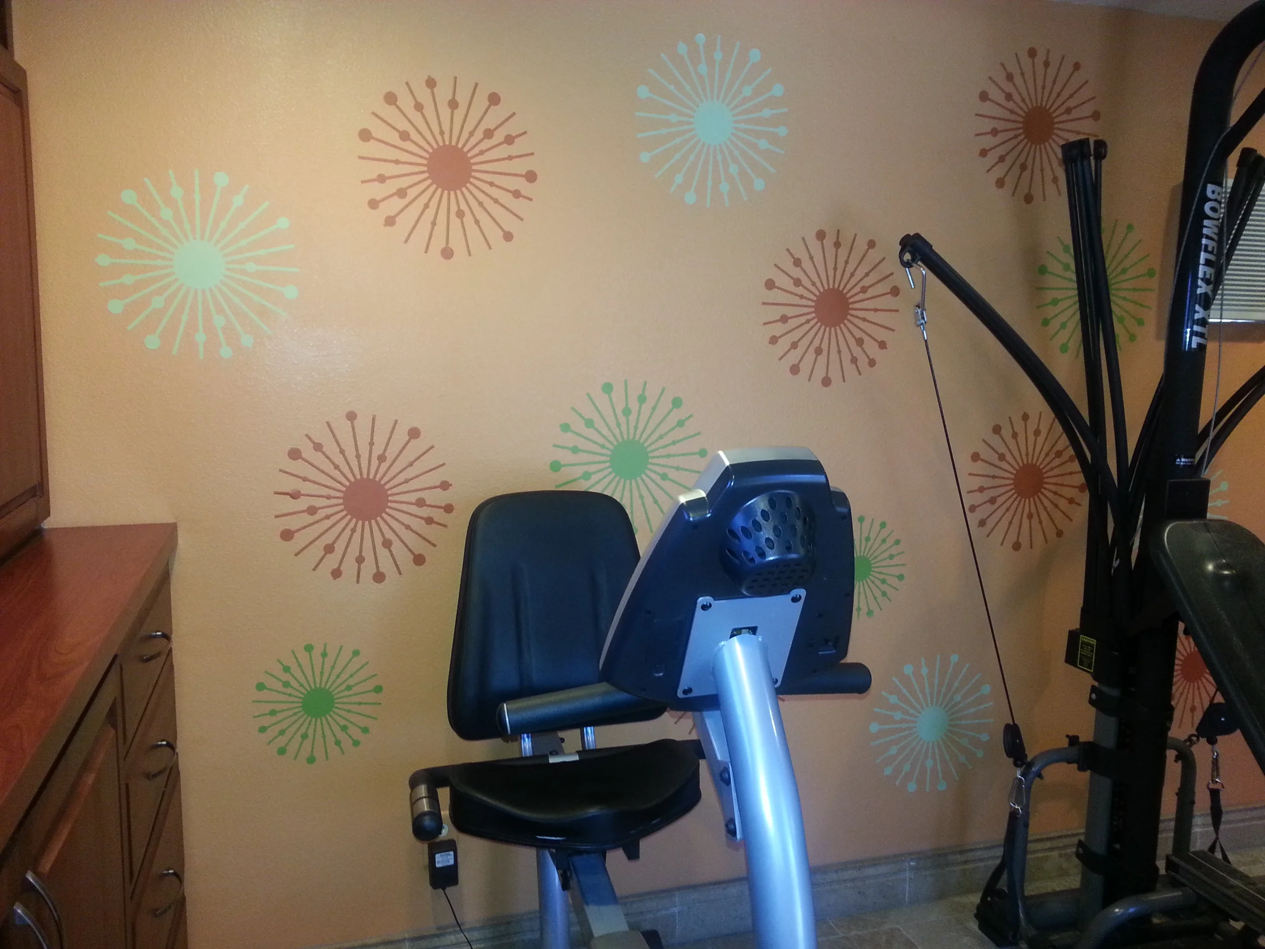 Atomic starburst wall decals in a home gym.