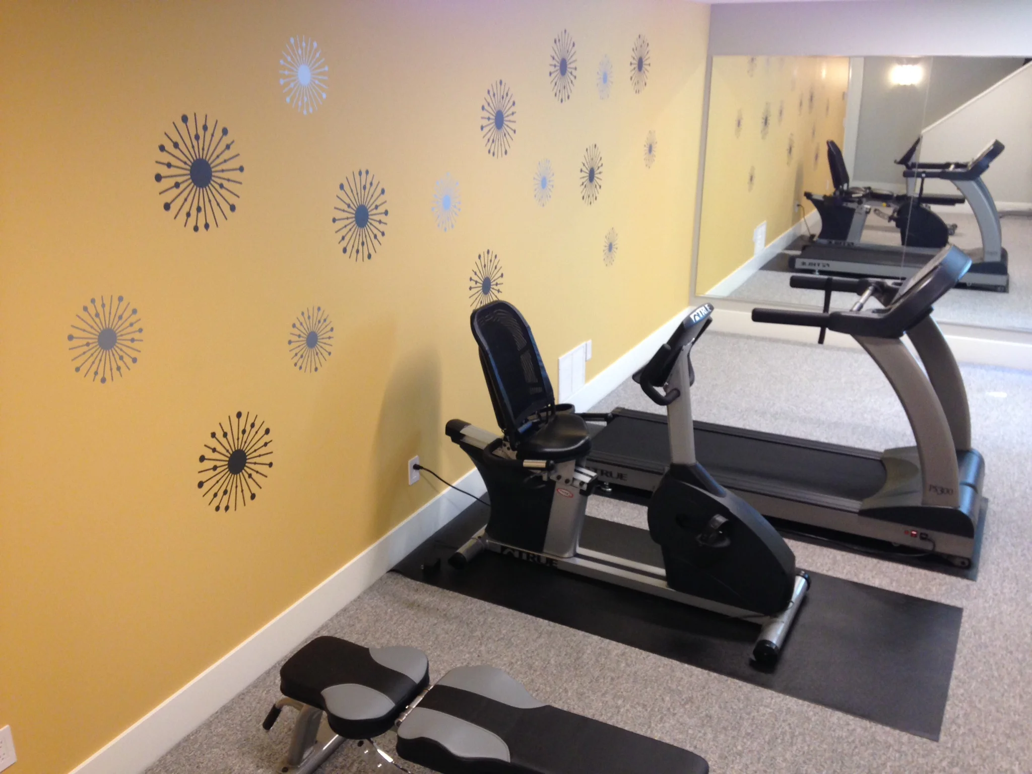 Atomic starburst wall decals in a home gym.