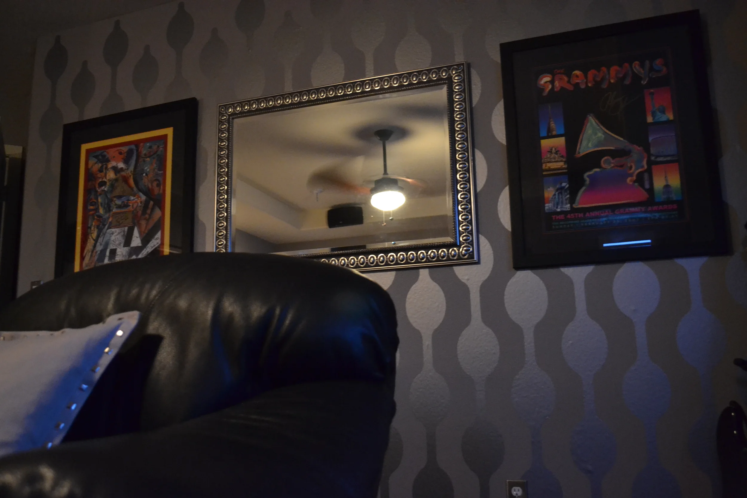 Geometric chain wall decal shown in metallic silver on a grey wall in a retro modern style rec room.