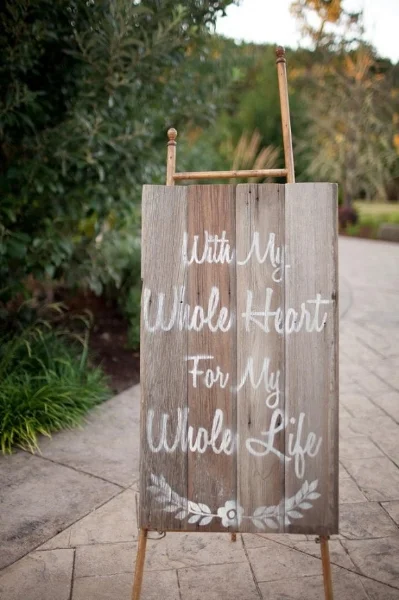 Custom, hand painted sign using reclaimed barn wood. Photo courtesy of Jamie Zanotti Photography.