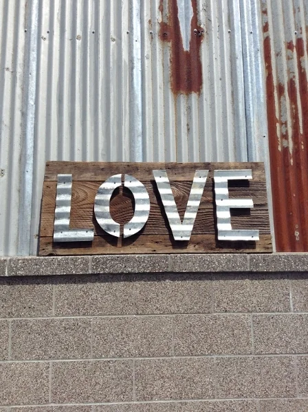 Handmade sign using vintage, reclaimed barn wood with naturally aged patina corrugated metal letters.