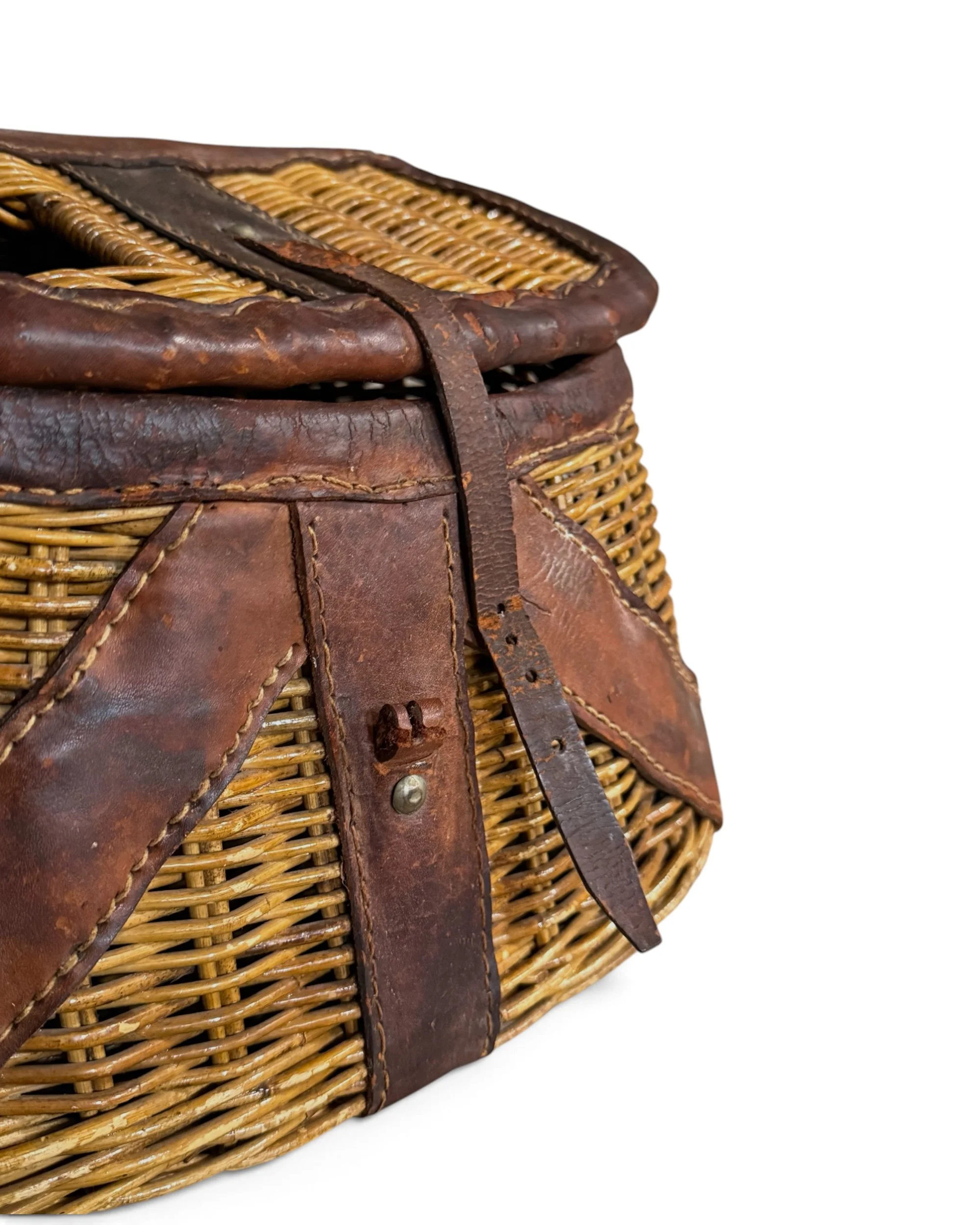 close up view leather details and woven wicker on vintage 1950s fishing creel