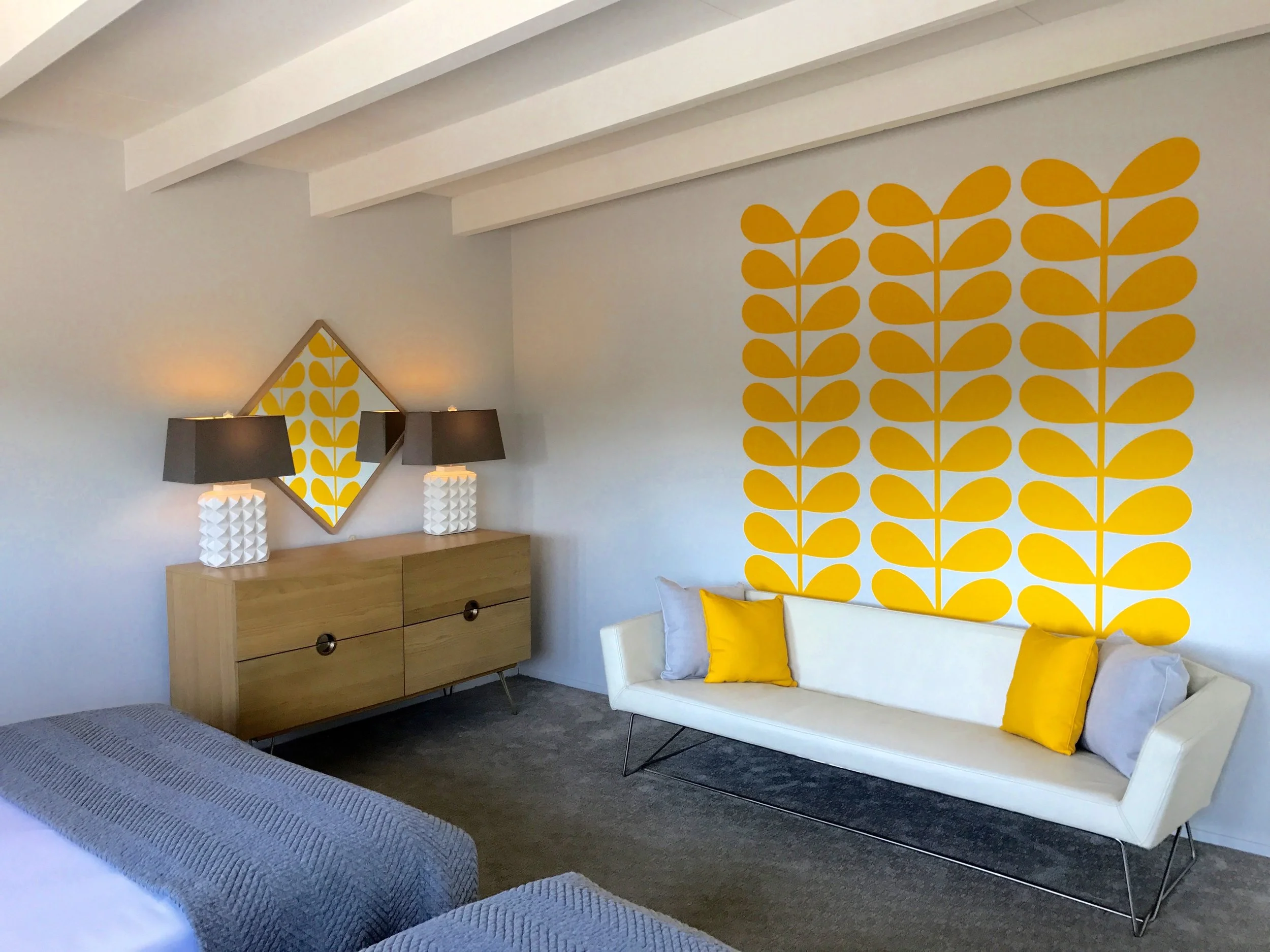 Retro floral wall decals by Wall Star Graphics in a mid century inspired primary bedroom in a vacation rental in Palm Springs, CA.