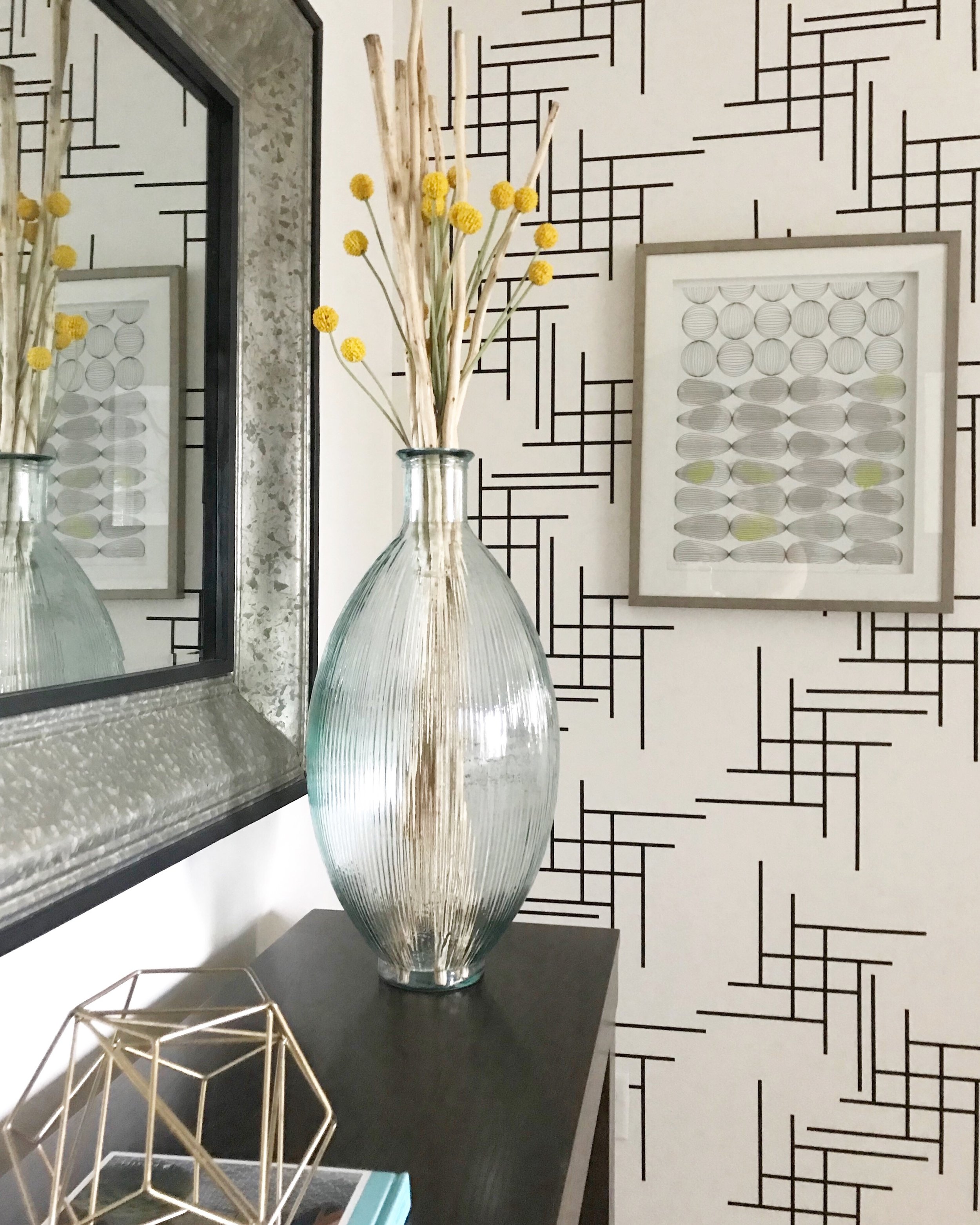 Modern geometric lines vinyl wall decal in black on white wall of a primary bedroom.