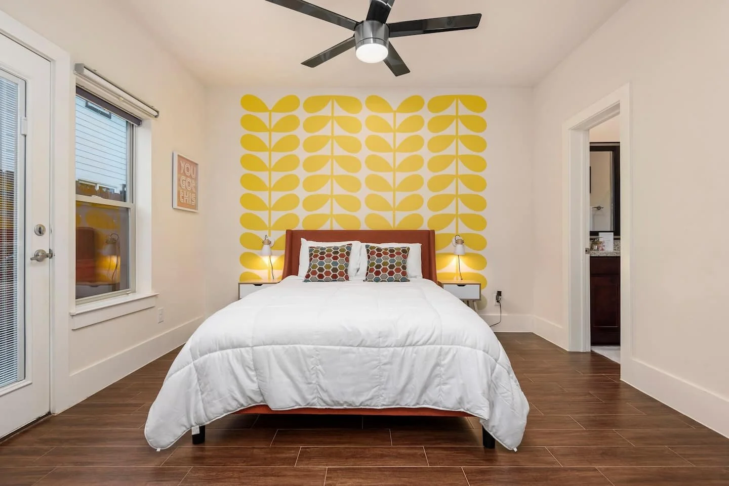 Retro floral wall decals by Wall Star Graphics in a mid century inspired bedroom in a vacation rental in Houston, TX.