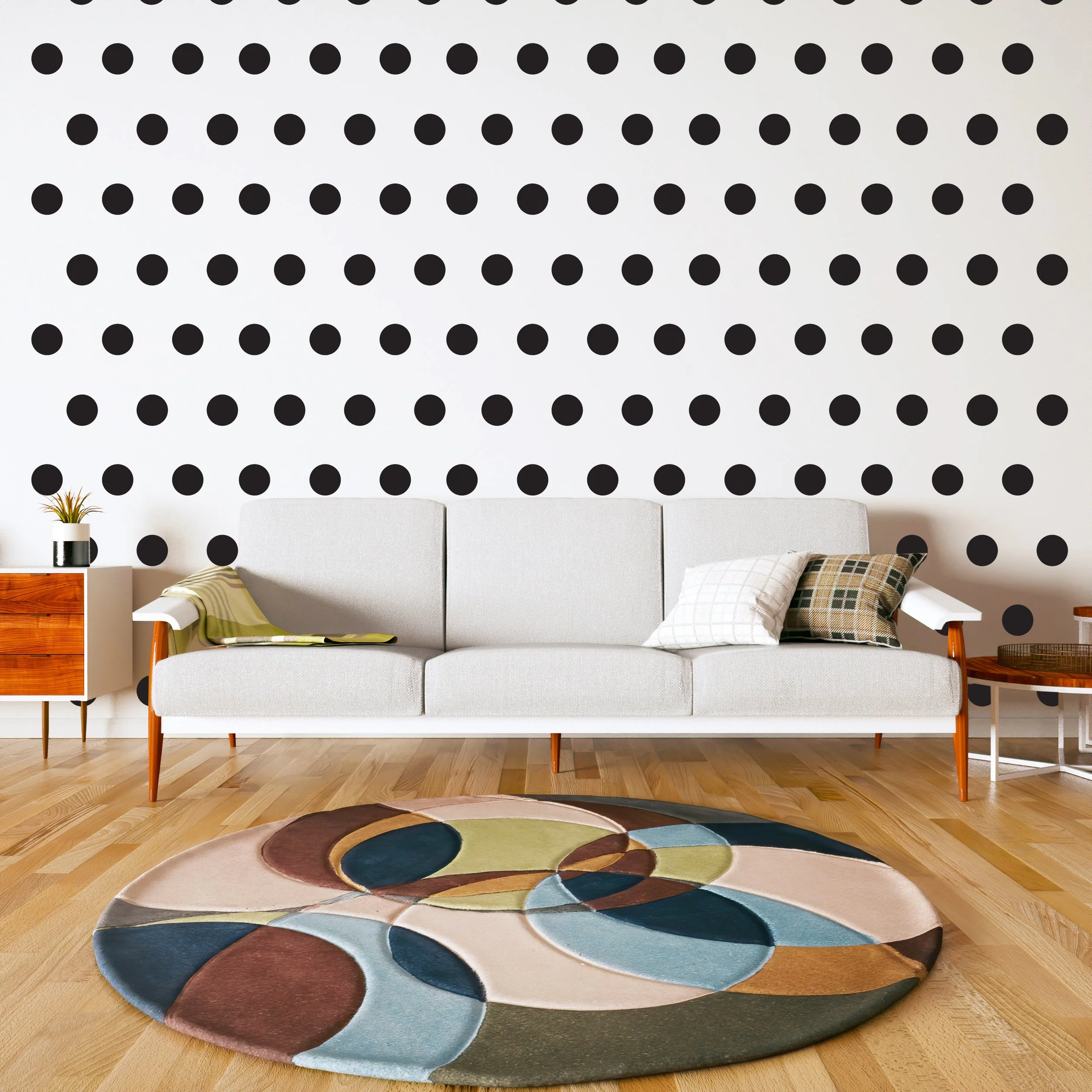 Black polka dot wall decals shown on a white wall of a retro living room.