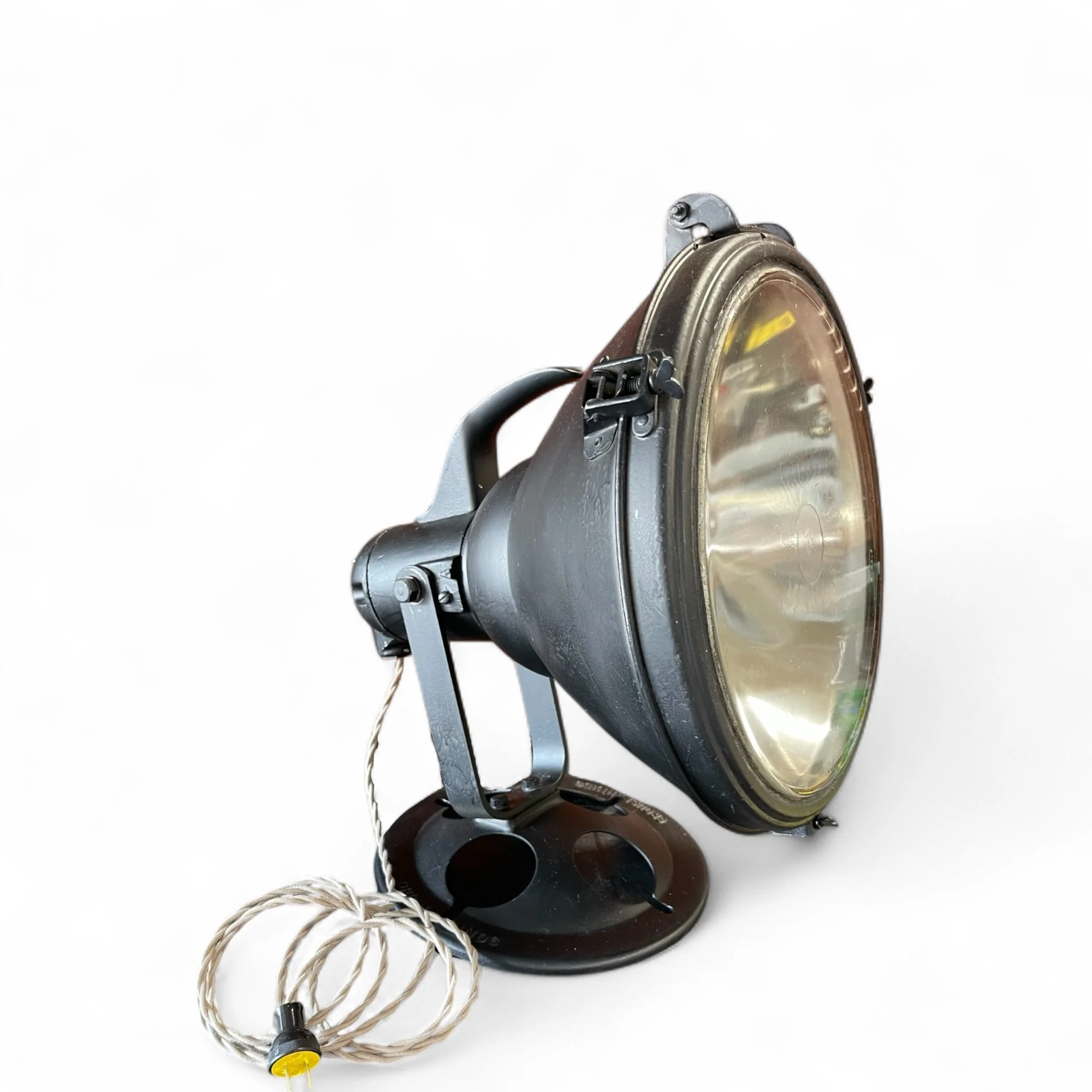 Full view of a large vintage Crouse Hinds nautical spotlight displayed on a sturdy metal stand, perfect for industrial and maritime-inspired decor.