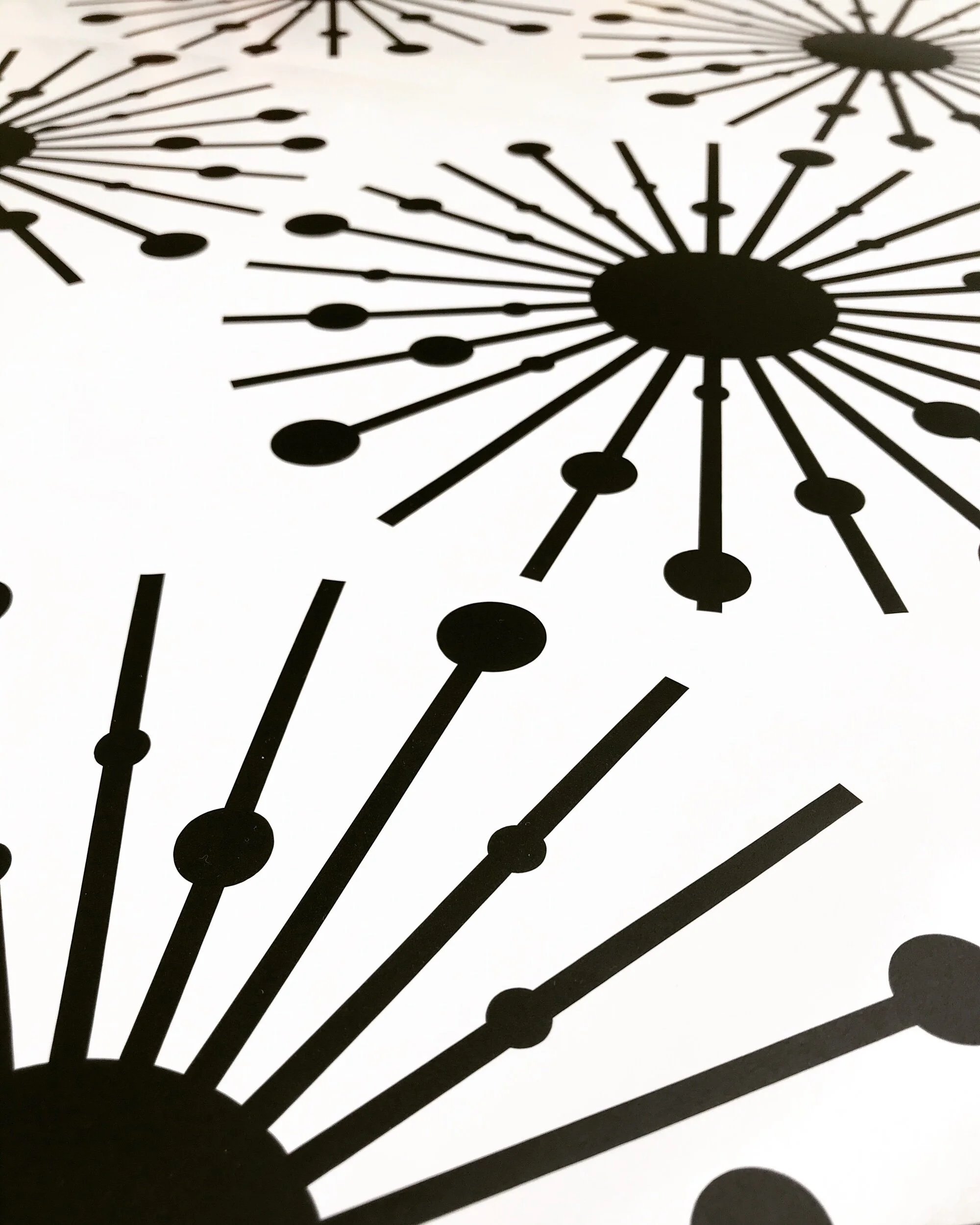 Atomic starburst wall decals in black.