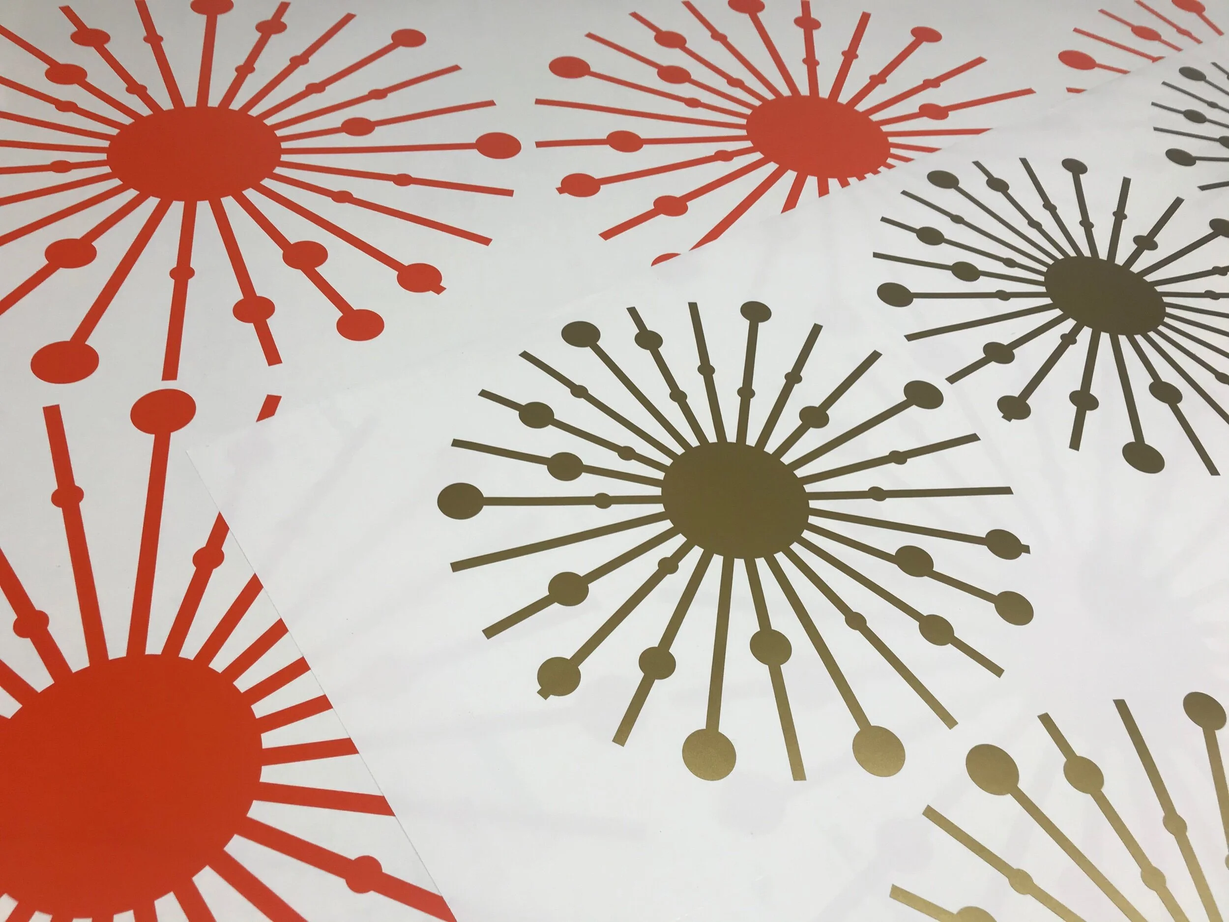 Atomic starburst wall decals in orange and metallic gold.