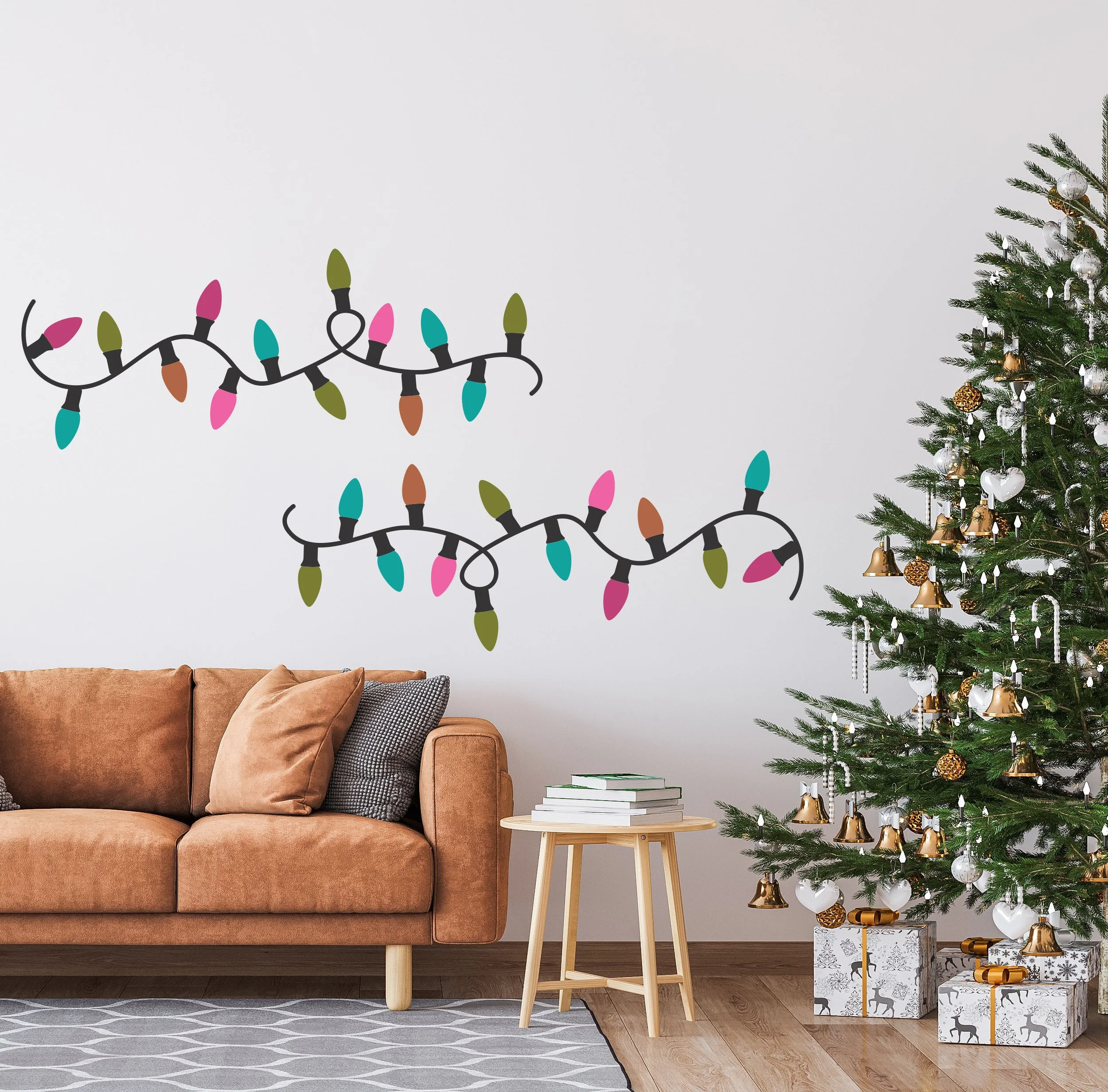 Christmas multicolor string of lights wall decal installed on a white wall behind a light brown modern couch next to a decorated Christmas tree.