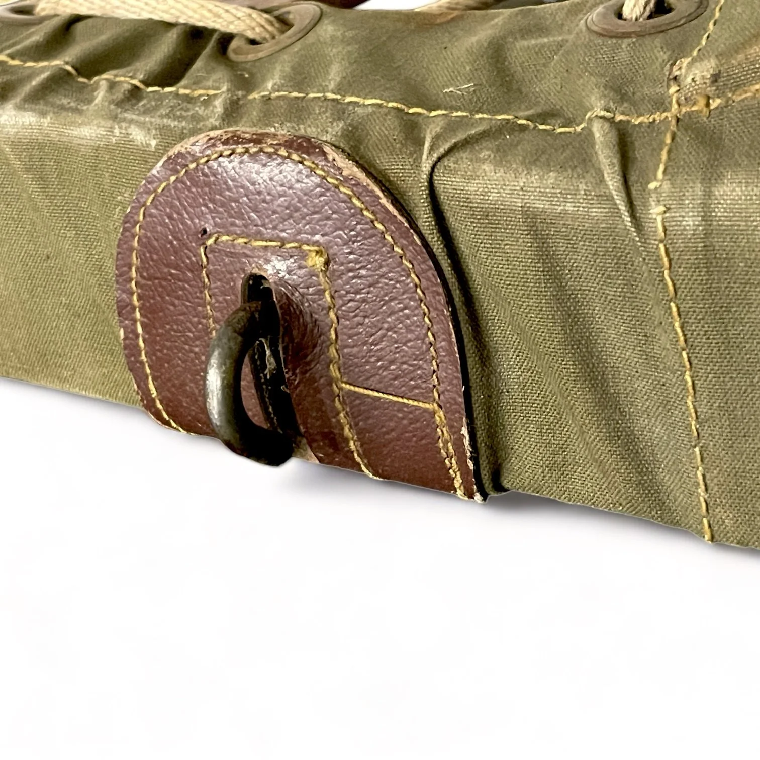 Close up of a vintage US Forest Service Wood Packboard Backpack and frame with Army green canvas, leather and metal accents with weathered wood