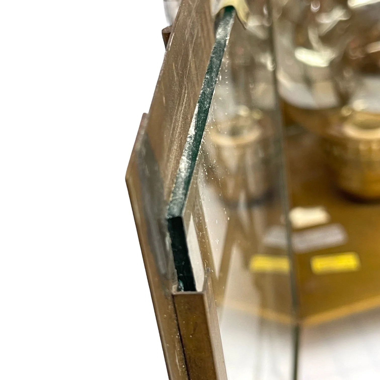 Side view of a brass and glass door on a vintage pair of hard wired brass nautical lantern lights suitable for indoor/outdoor use, made by Hollywood Lighting Fixture Co.