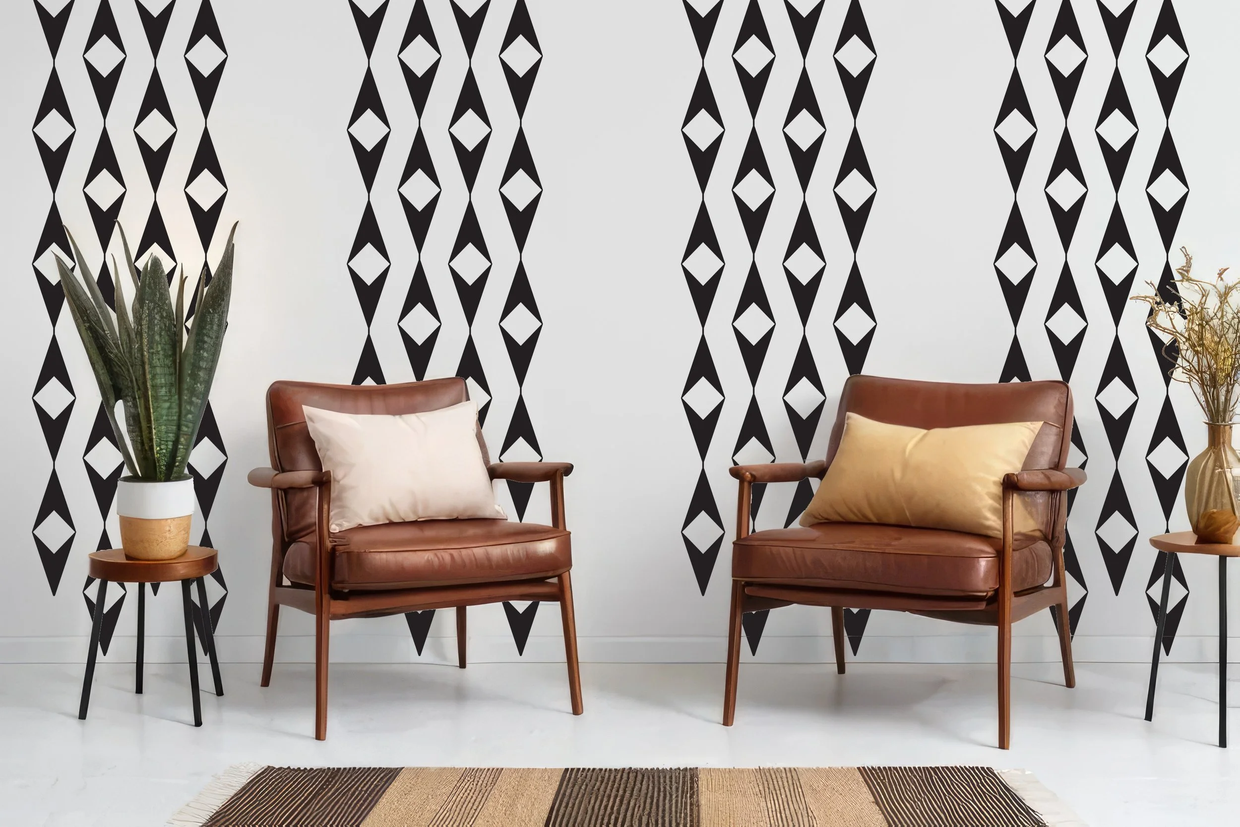 Geometric design wall decal in a diamond repeatable pattern shown in black on a white wall with two nut brown leather chairs, side tables, and a striped area rug.