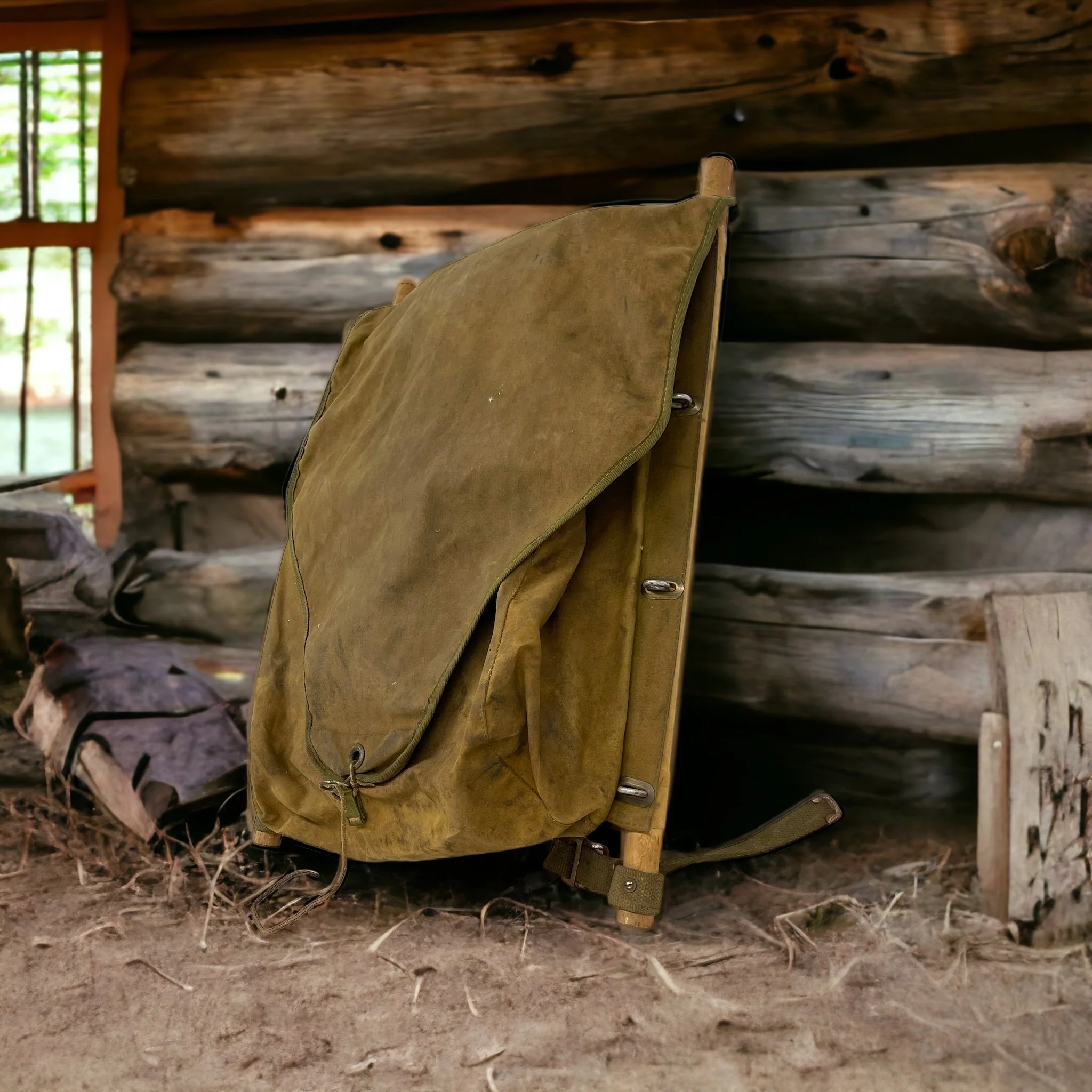 A vintage White Stag trapper's style Army green backpack with wooden frame made by Hirsch Weis Canvas Prod. Co., Portland, Oregon. Made in USA, leaning against a rustic cabin in the woods.